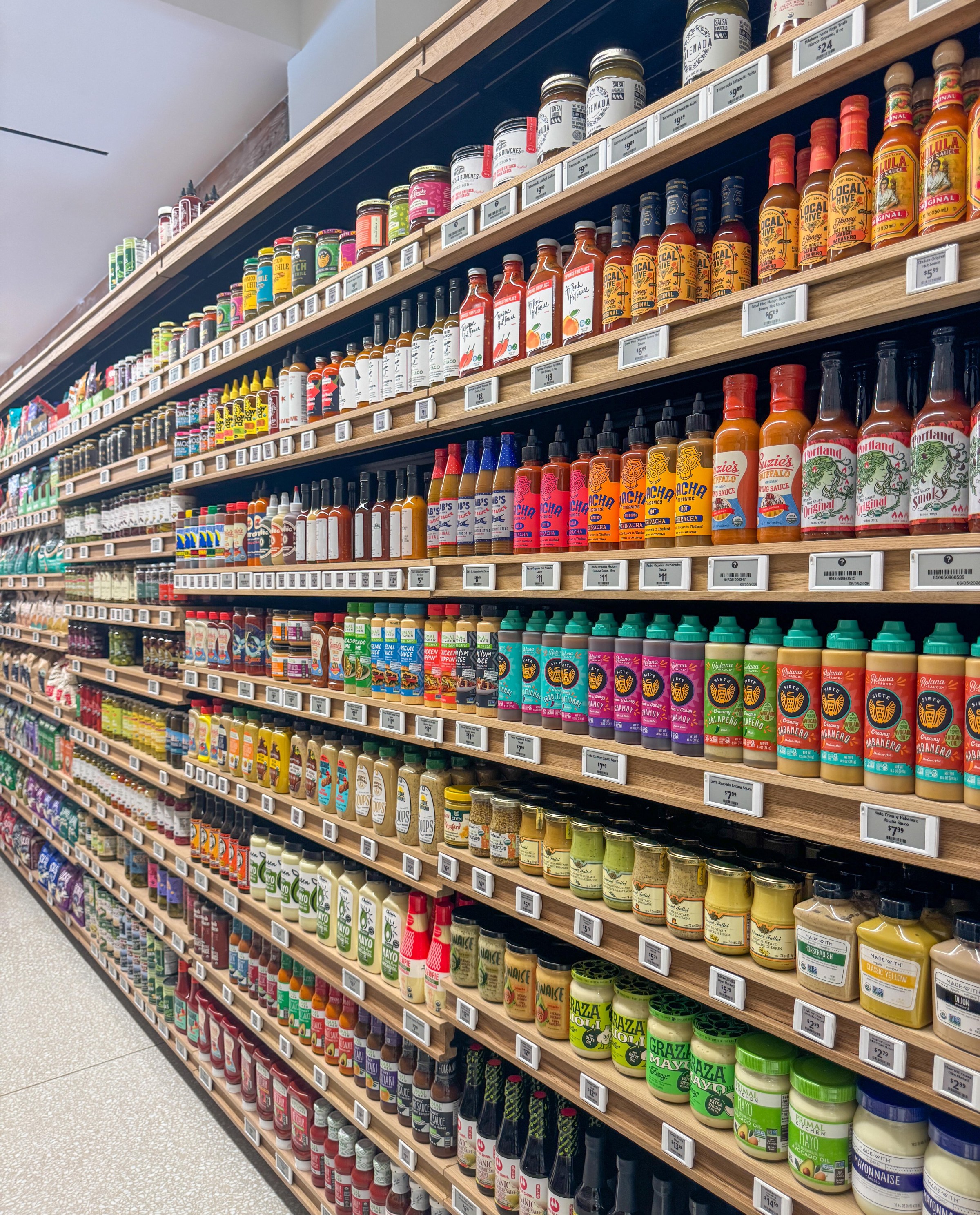 Rows of sauces and olives at Laurel Supply.