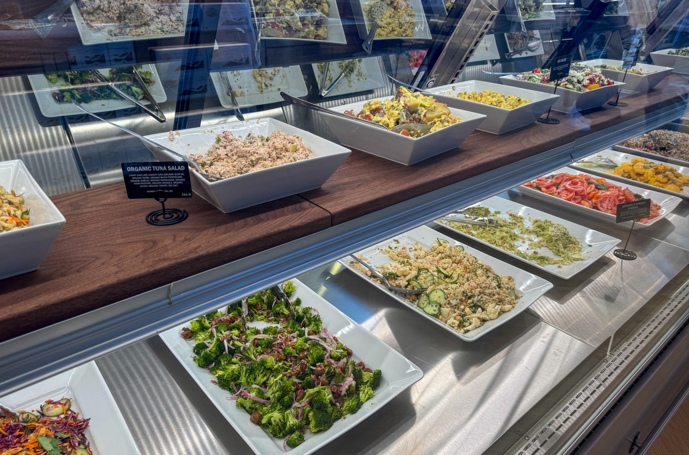 Salads in a refrigerated case at Laurel Supply.