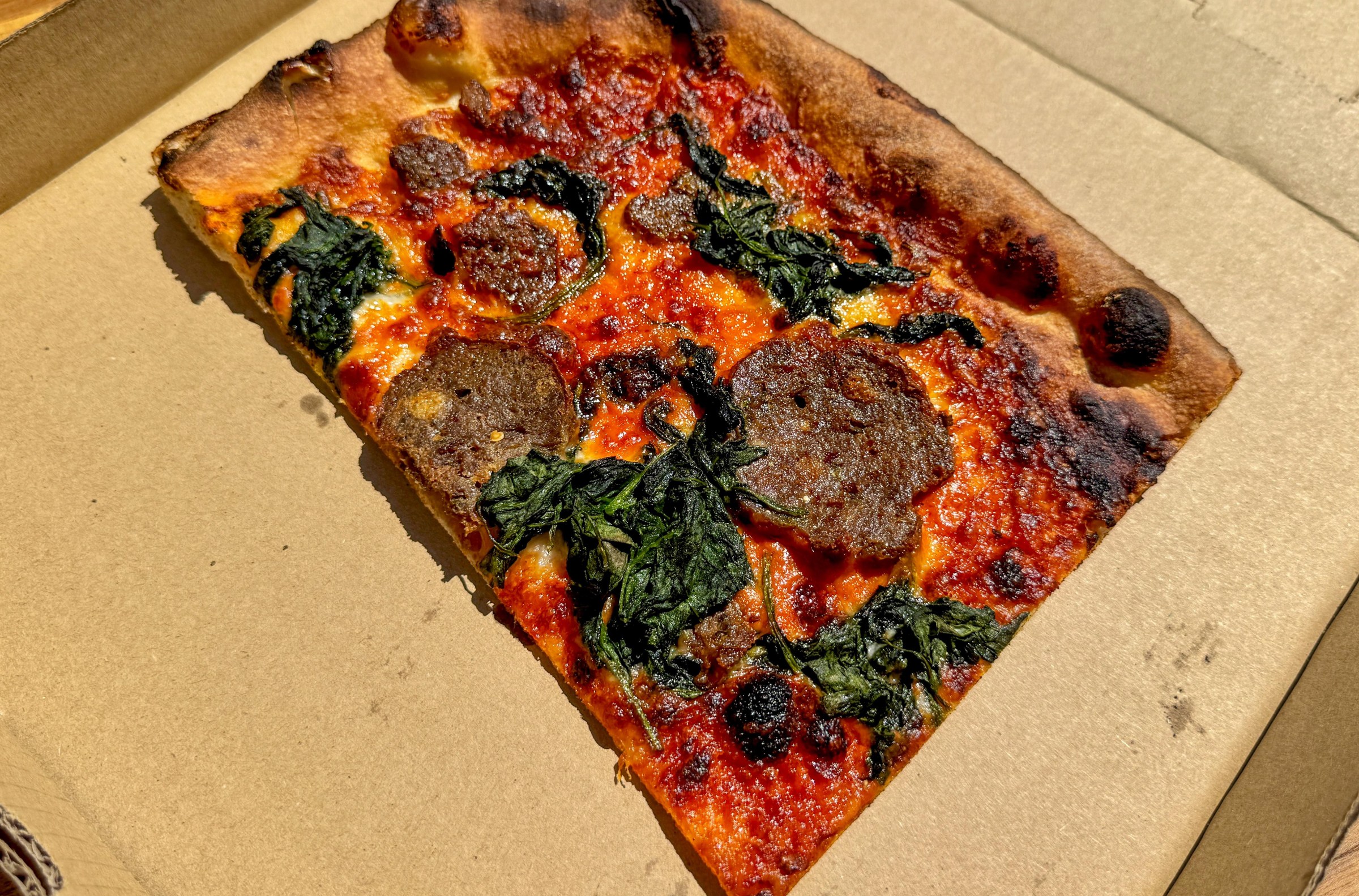 Slice of vodka meatball pizza at Laurel Supply.