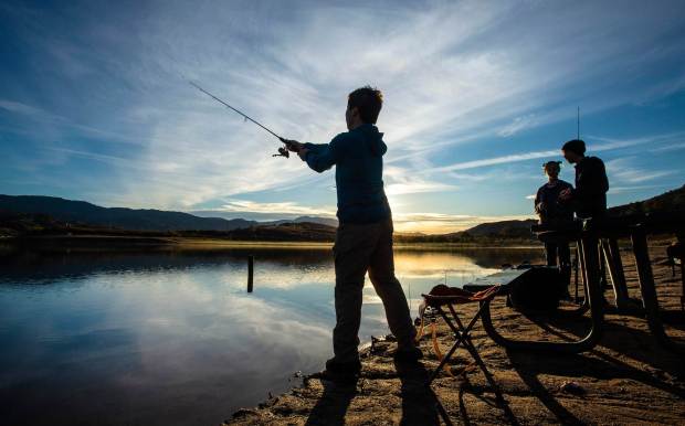 Daniel Gonzalez of Irvine casts his line into the water as he stands along the west shore of Irvine Lake in Silverado early on Friday morning, December 6, 2019, after the lake was stocked with trout earlier this week for the first time in three years. The lake will be open for fishing through the weekend. (Photo by Mark Rightmire, Orange County Register/SCNG)
