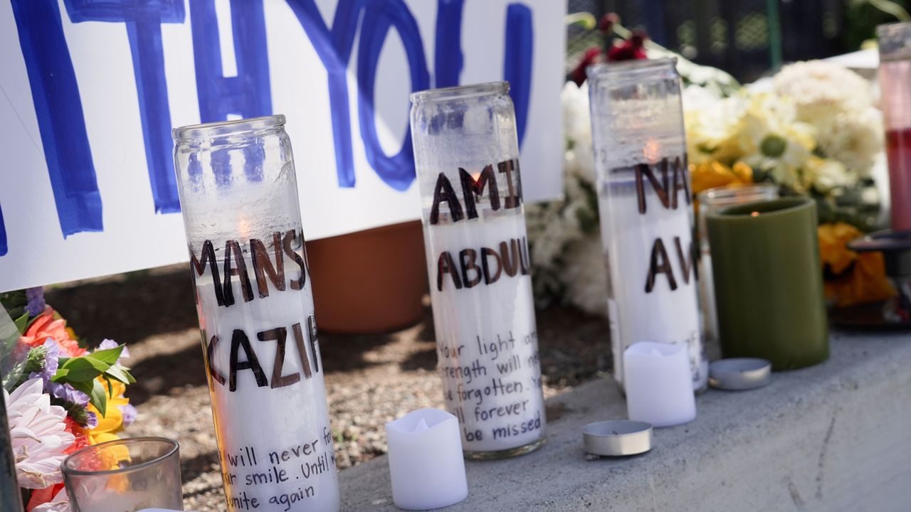Candles with victims names are placed outside the Islamic Center of San Diego in the aftermath of a shooting on Wednesday, May 20, 2026, in San Diego. (AP Photo/Ty Oneil)