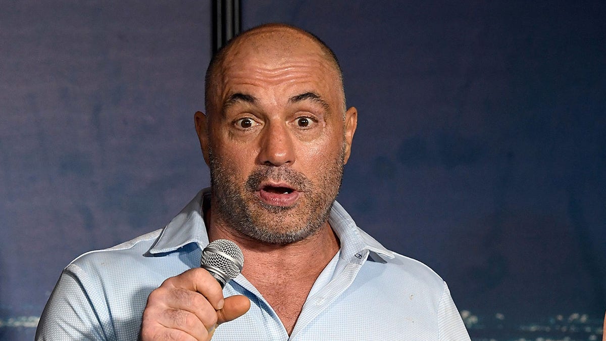 Joe Rogan speaking into a microphone during a podcast recording.