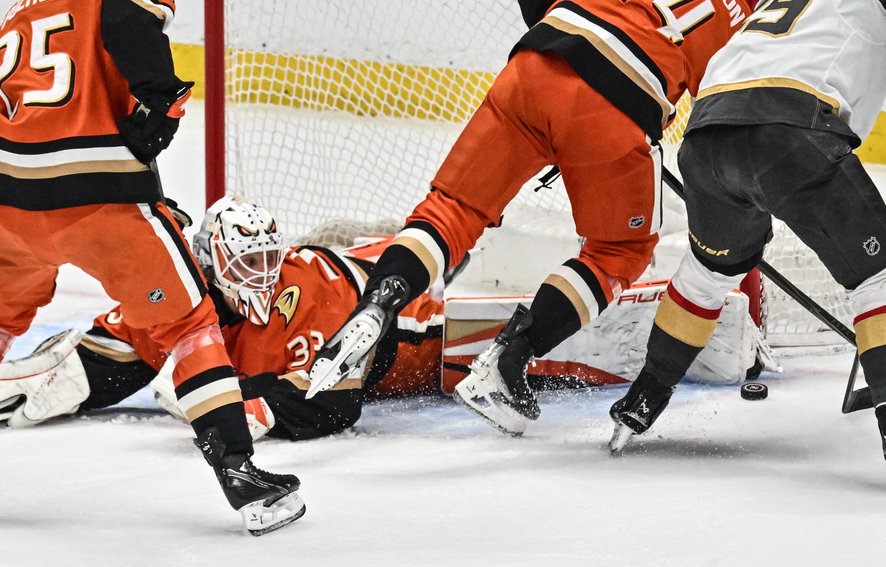 The Ducks Ville Husso (33) is on the ground as...