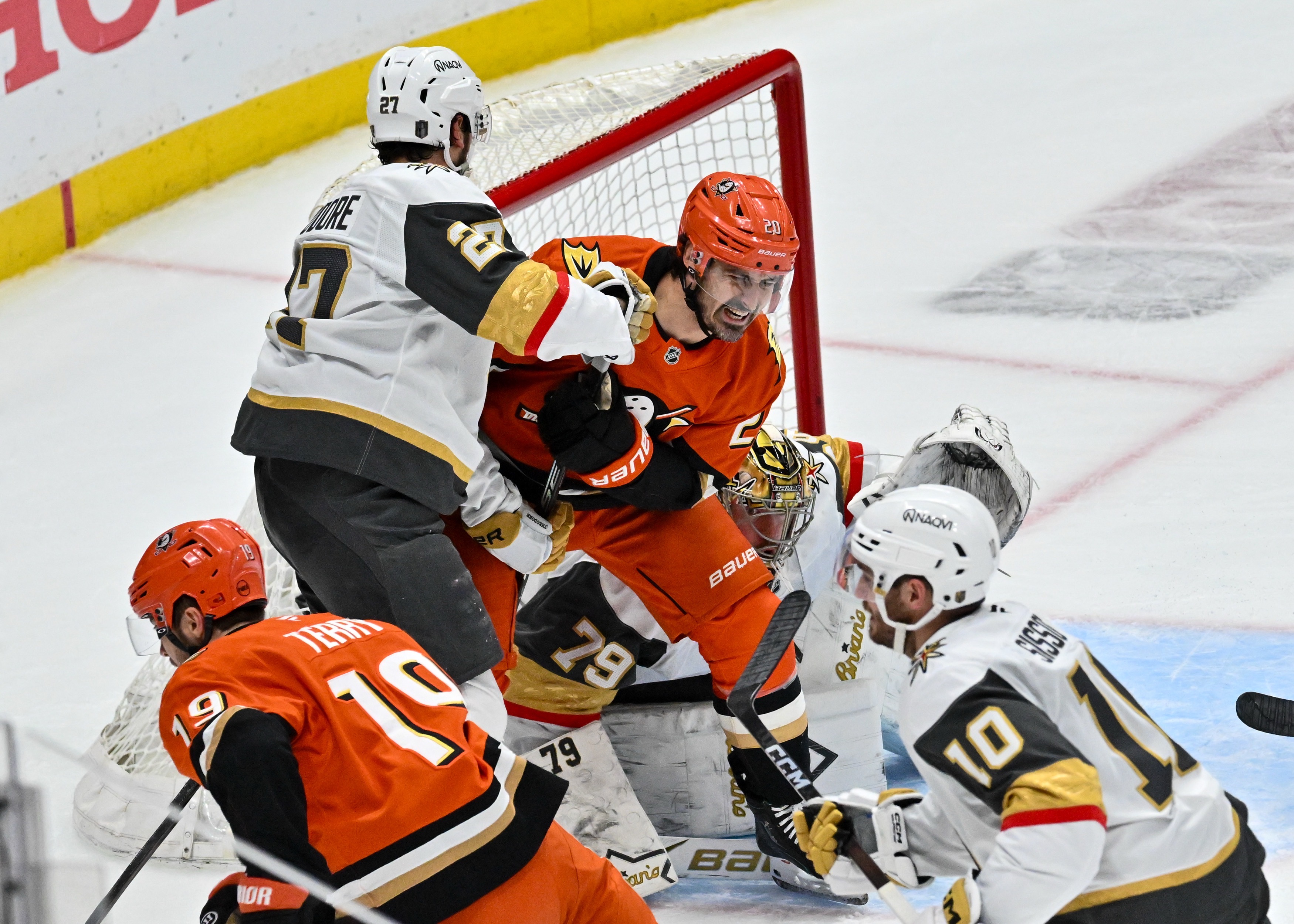 The Chris Kreider (20) is smashed between Vegas Golden Knights...