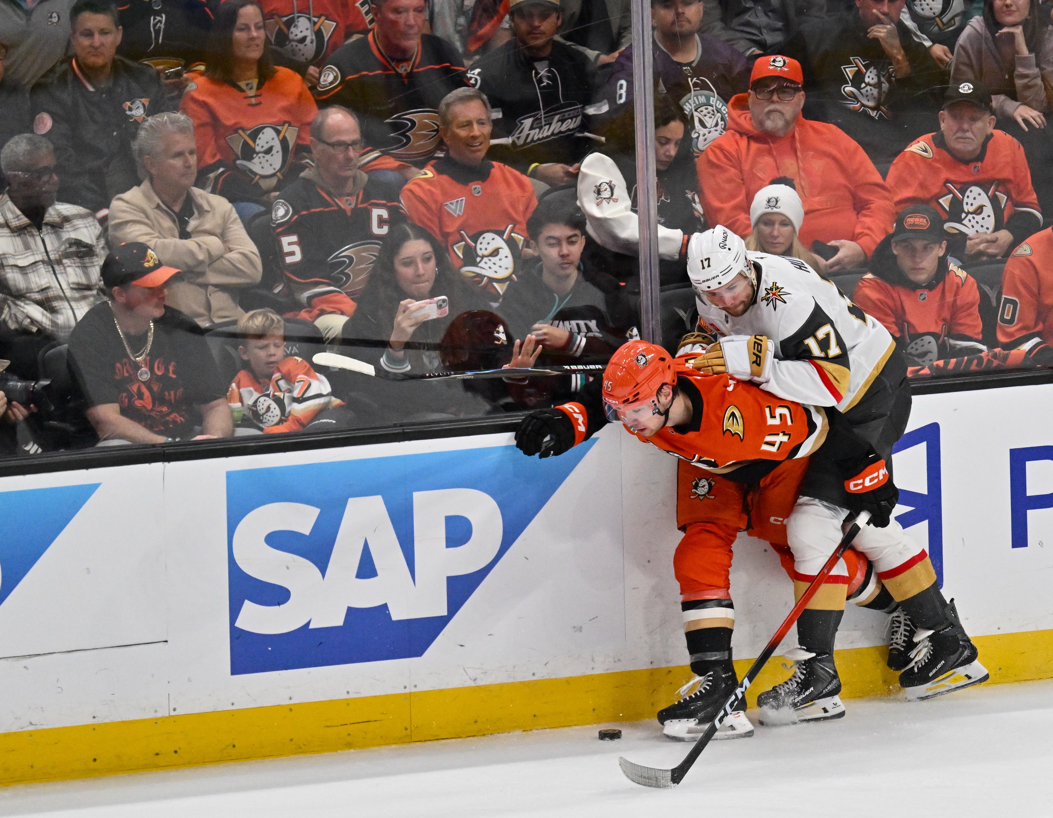 The Ducks’ Beckett Sennecke, left, and the Vegas Golden Knights’...