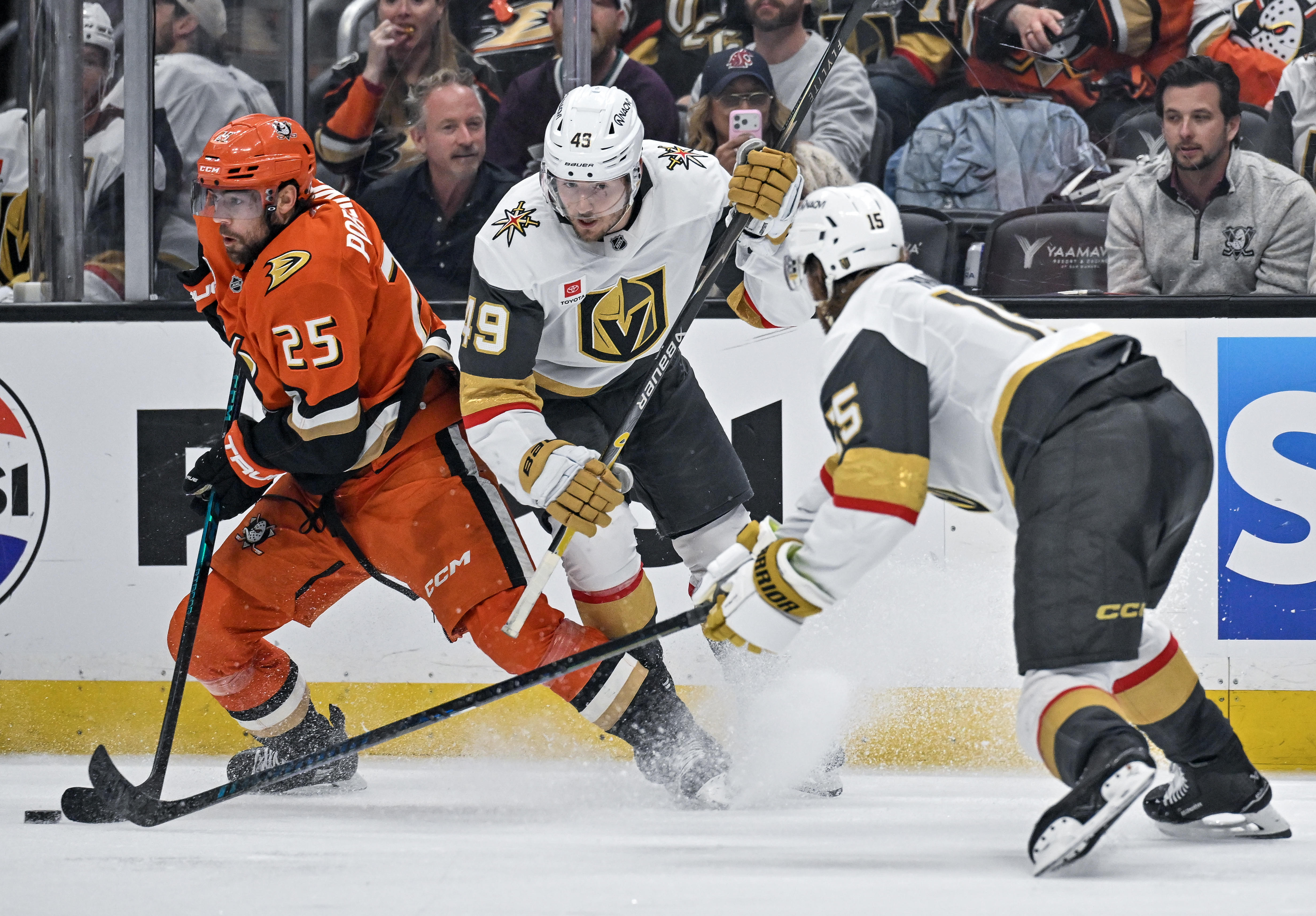 The Ducksâ Ryan Poehling (25), left, fends off the Golden...