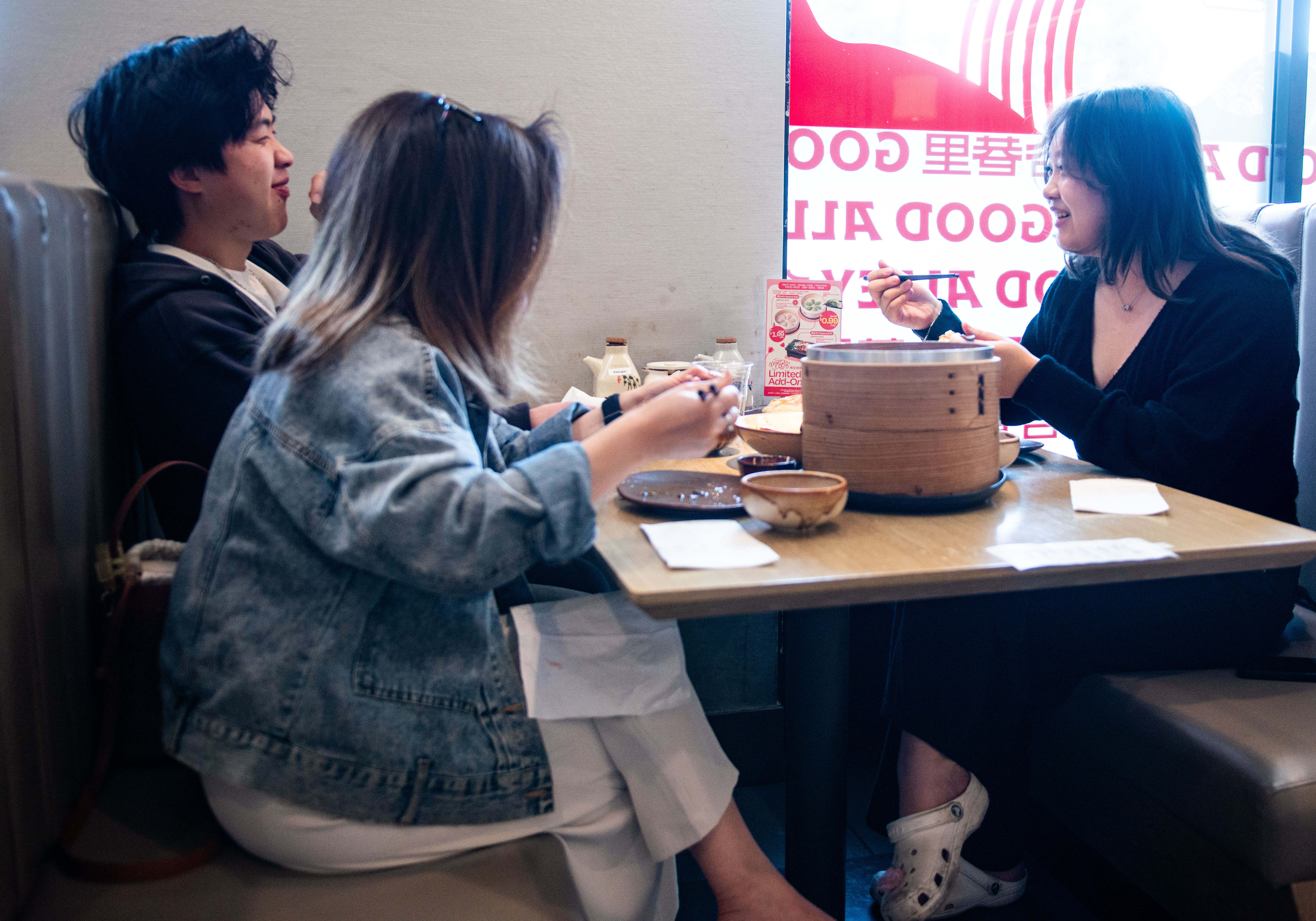 Ian Ngo, left, Samantha Tong and Kelly Tong eat lunch...