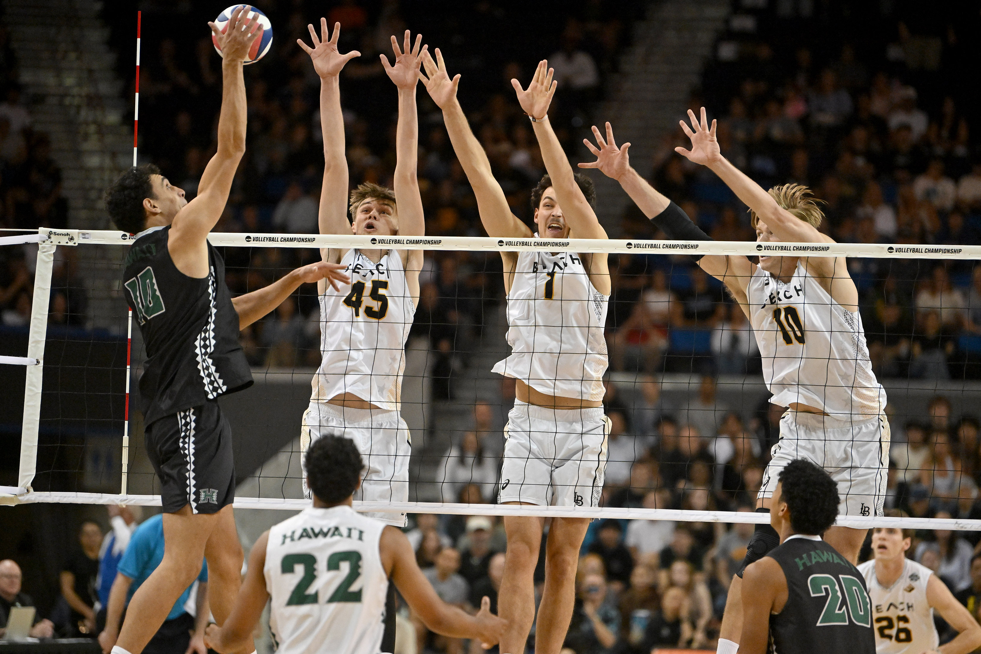Hawaiiâs Kristian Titriyski spikes the ball against Long Beach State...