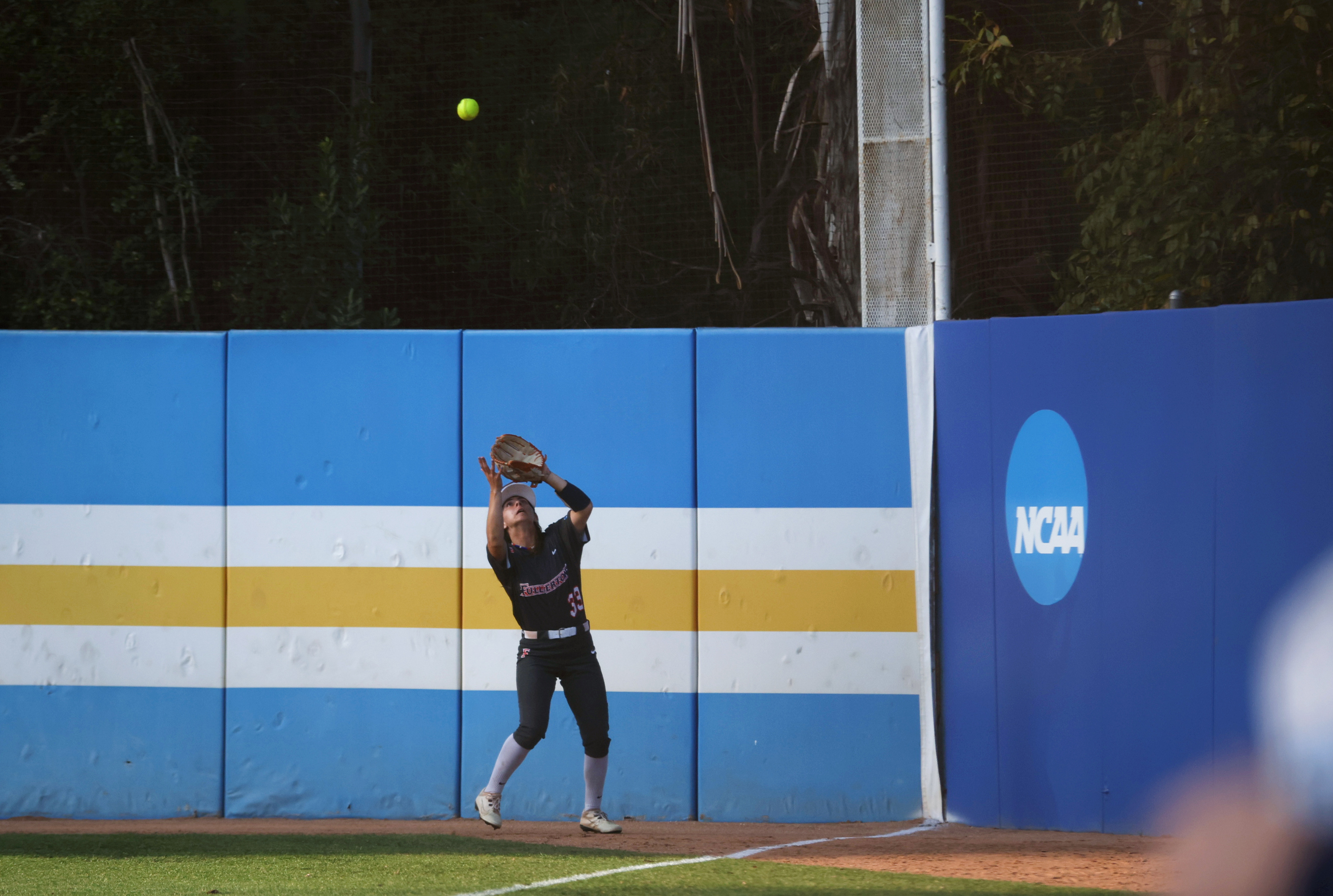 Cal State Fullertonâs Maggie Paulovich (33) gets underneath a fly-ball...
