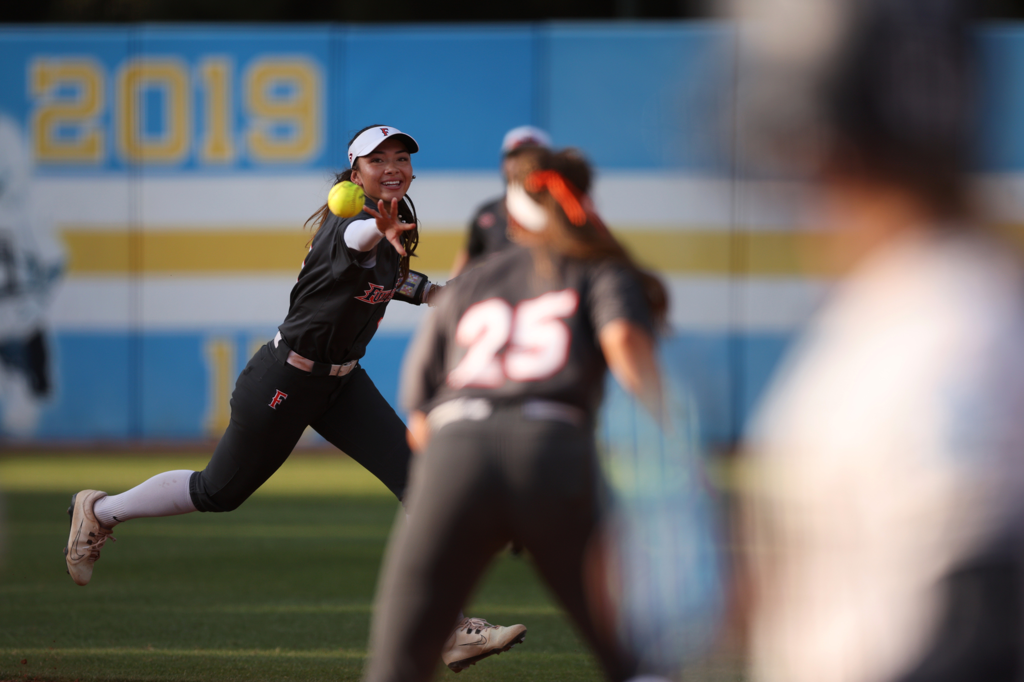 Cal State Fullertonâs Colby McClinton, left, tosses the ball to...