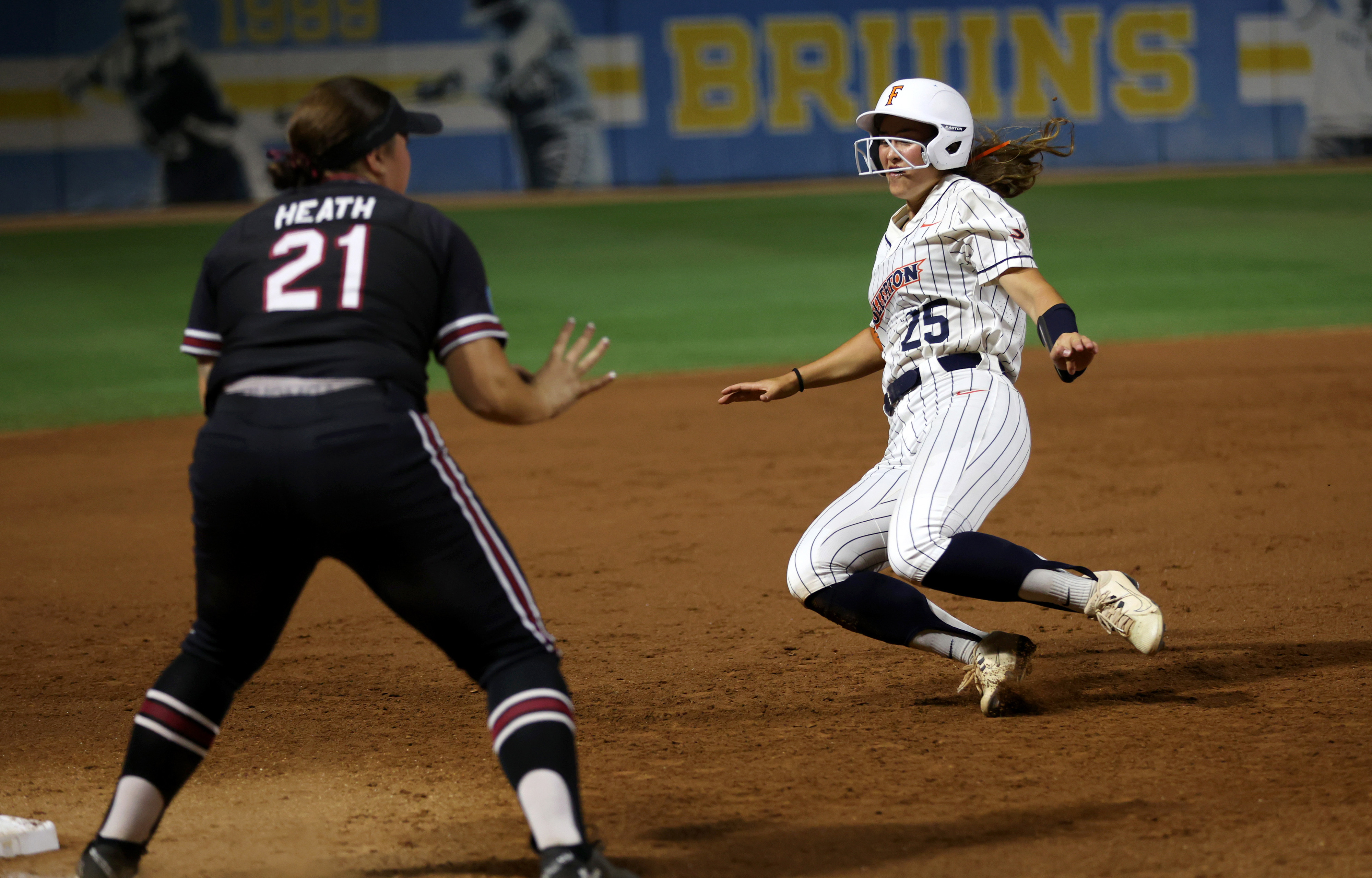 Cal State Fullertonâs Ava Arce (25) begins to slide into...