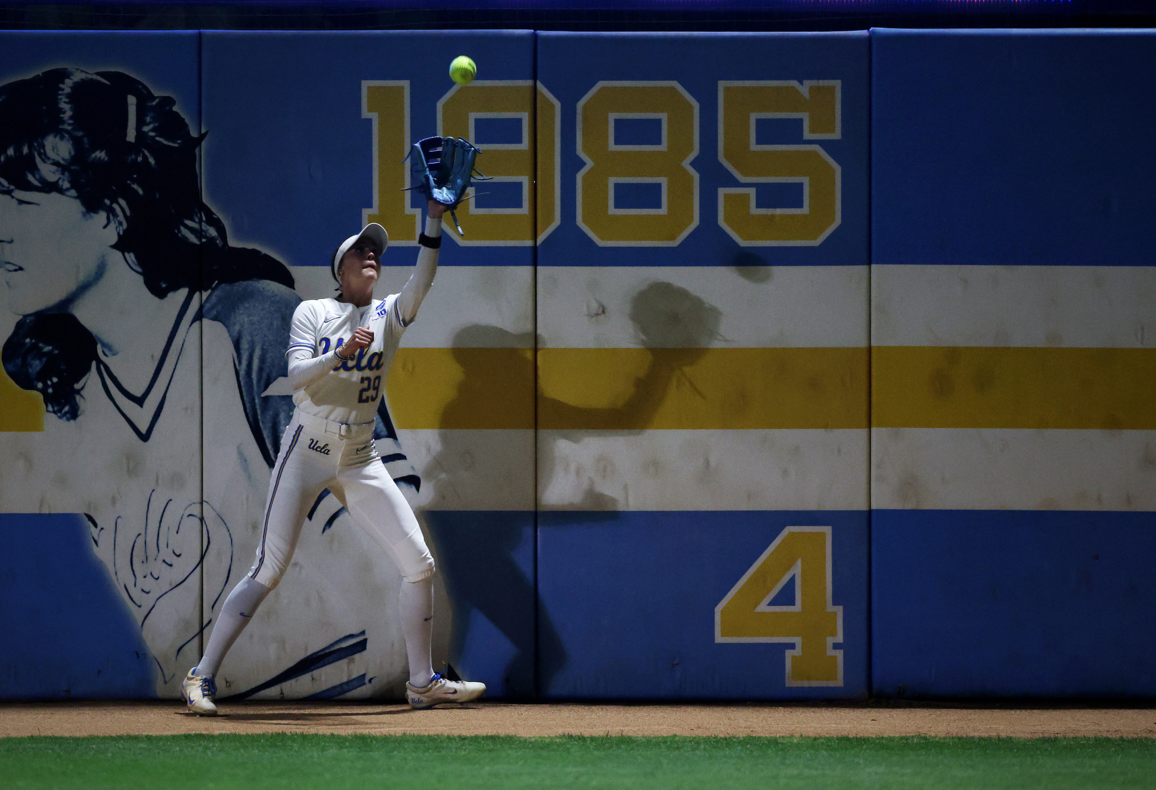 UCLAâs Rylee Slimp catches a fly ball for an out...