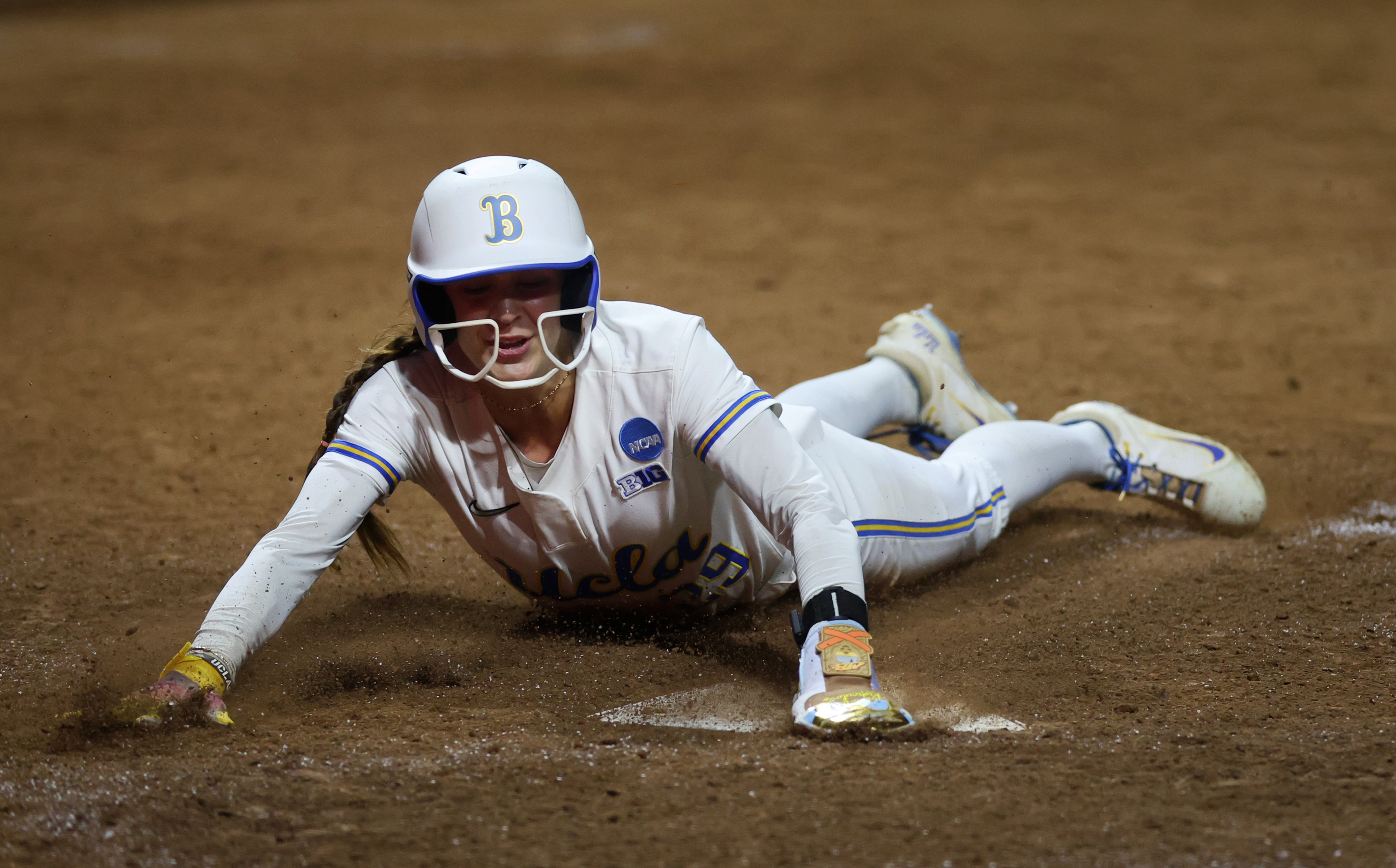UCLAâs Rylee Slimp slides home to score the game-winning run...