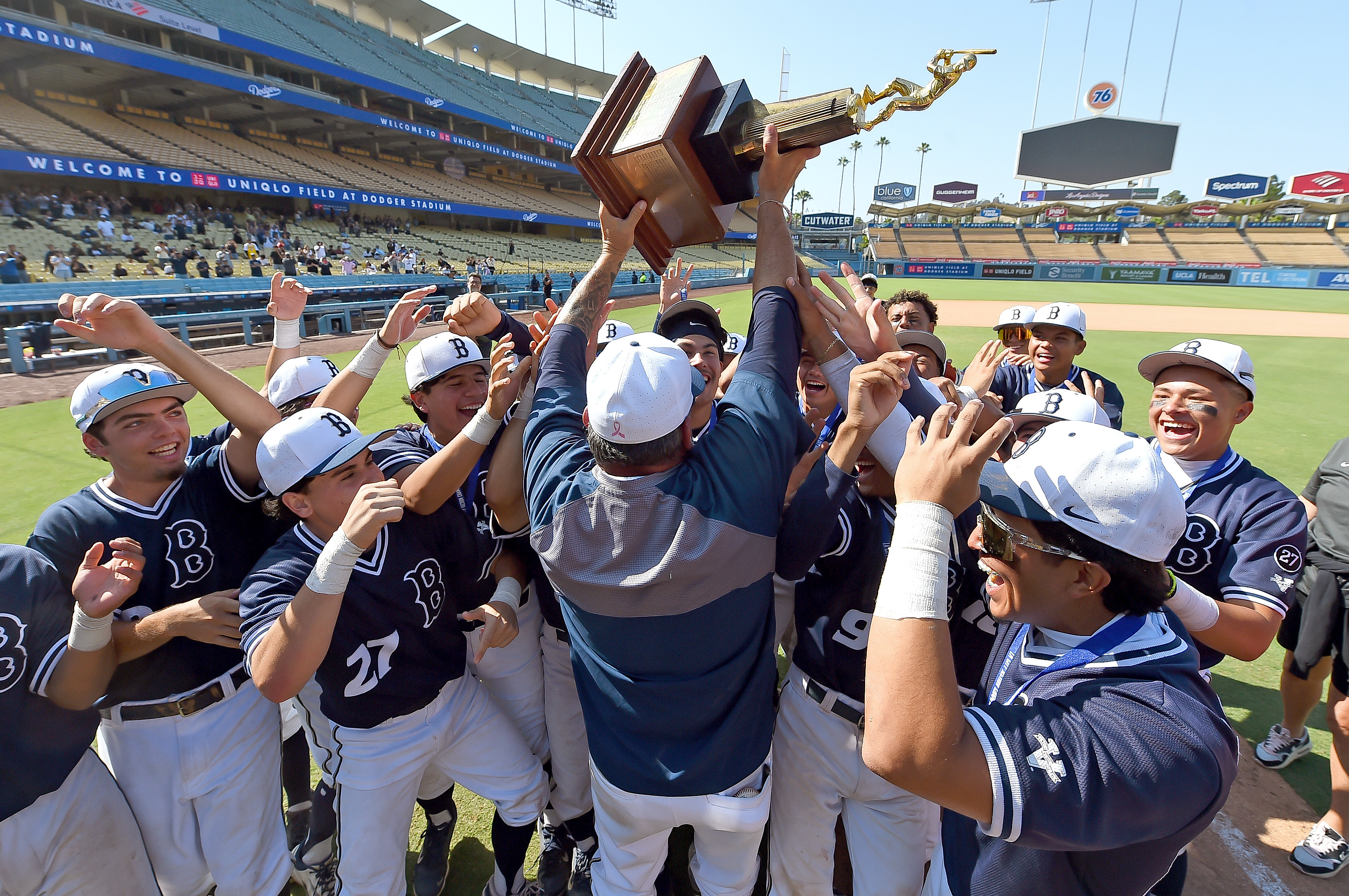Birmingham players surround coach Matt Mowry as he raises the...