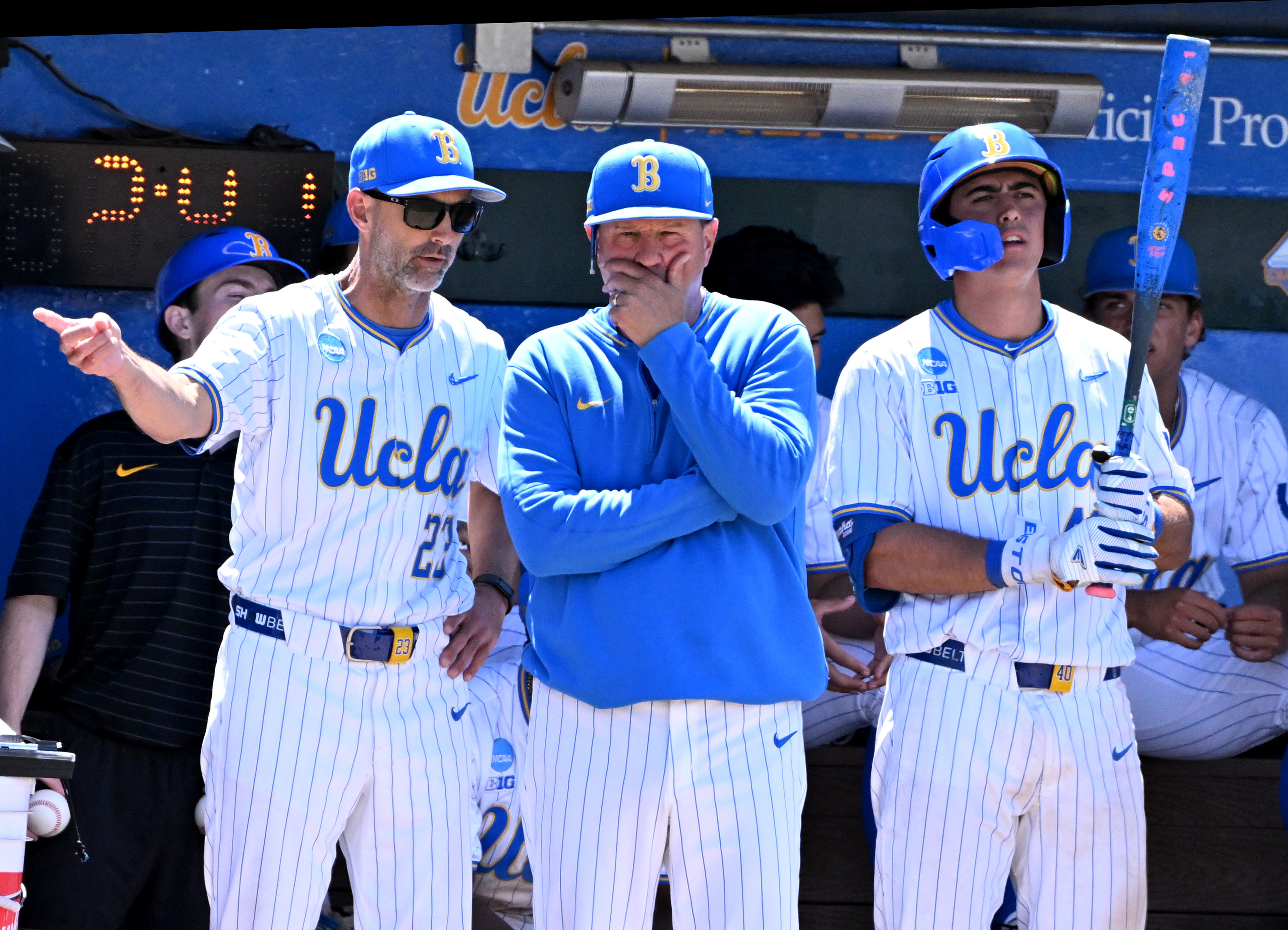 UCLA head coach John Savage, center, looks on during the...
