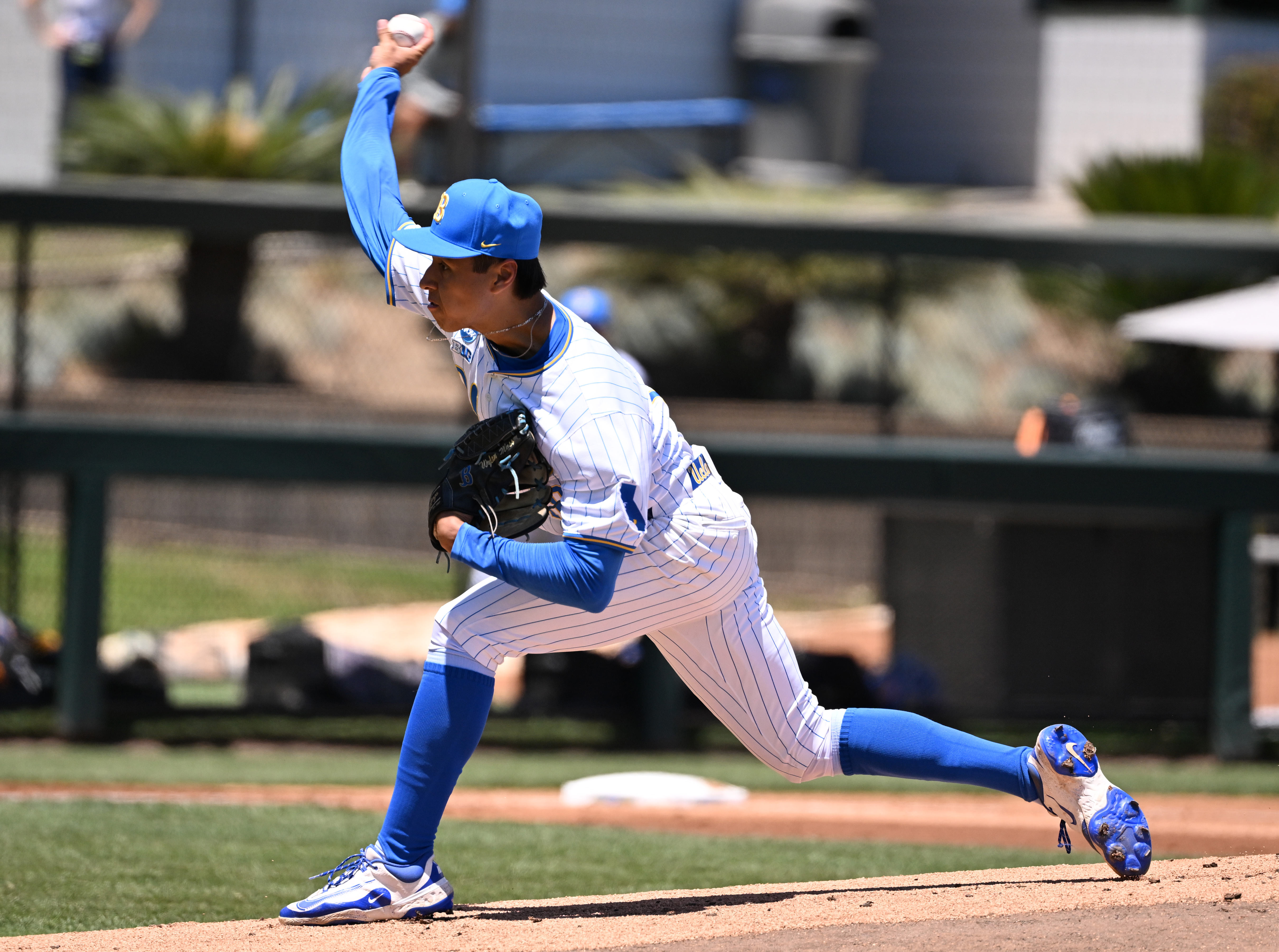 Starting pitcher Wylan Moss #18 of the UCLA Bruins throws...