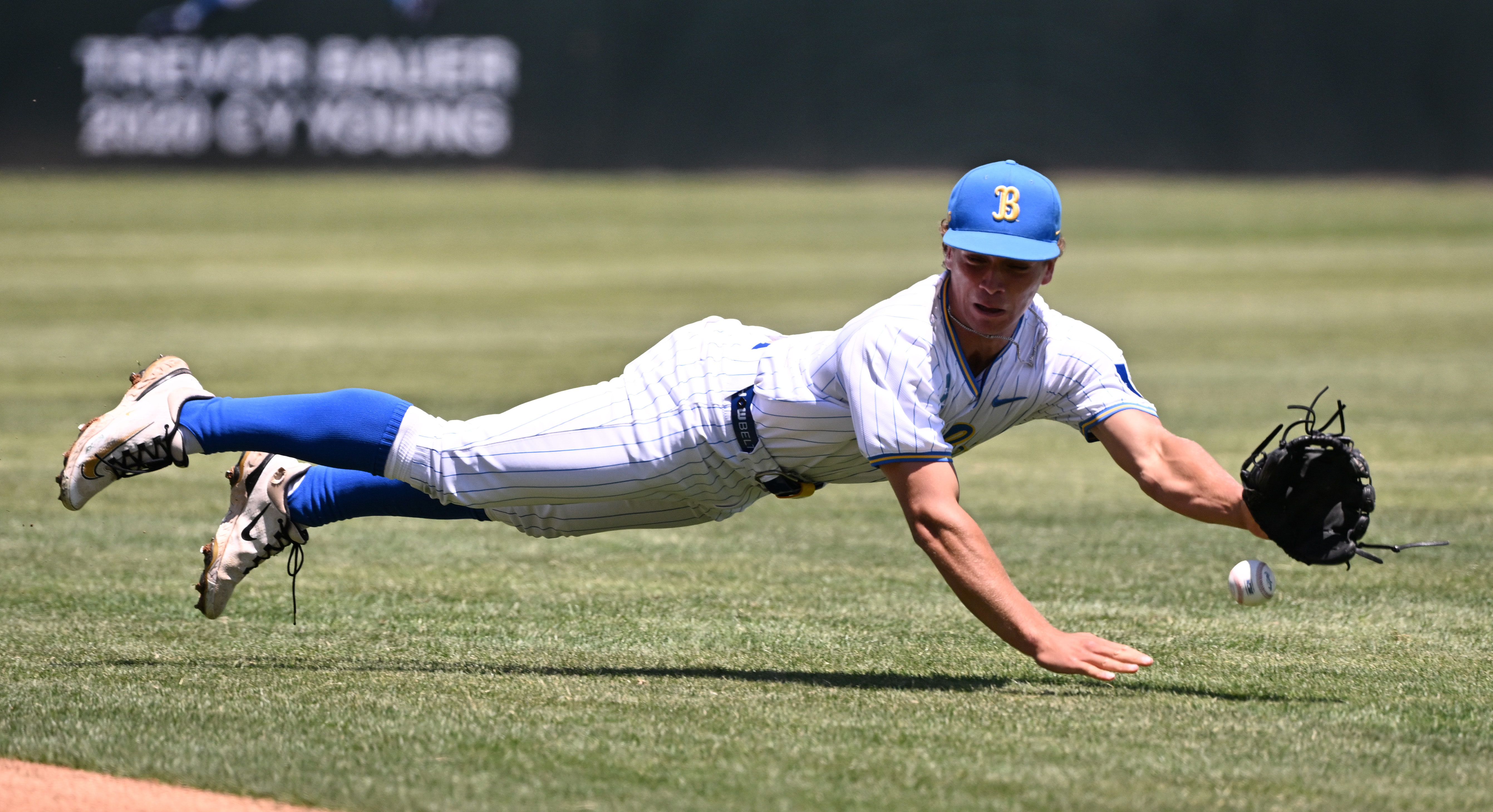 Second baseman Phoenix Call #4 of the UCLA Bruins dives...