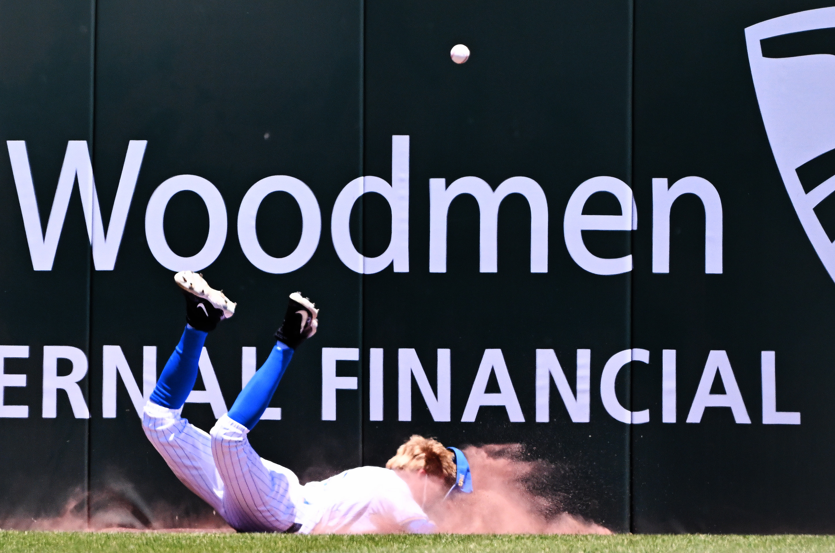 Center fielder Payton Brennan #11 of the UCLA Bruins dives...