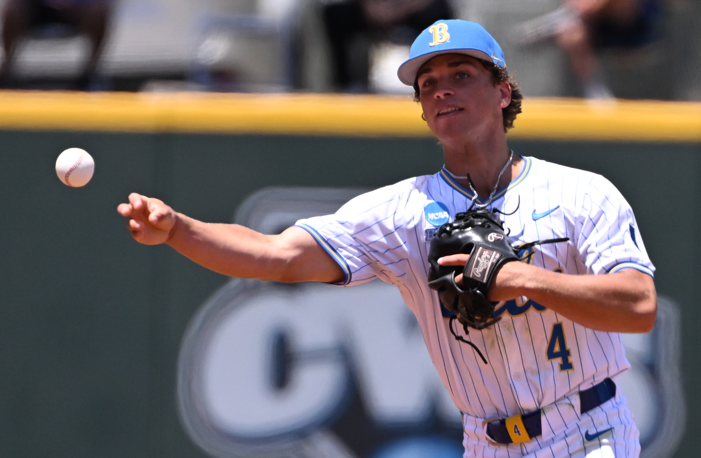 Second baseman Phoenix Call #4 of the UCLA Bruins throws...