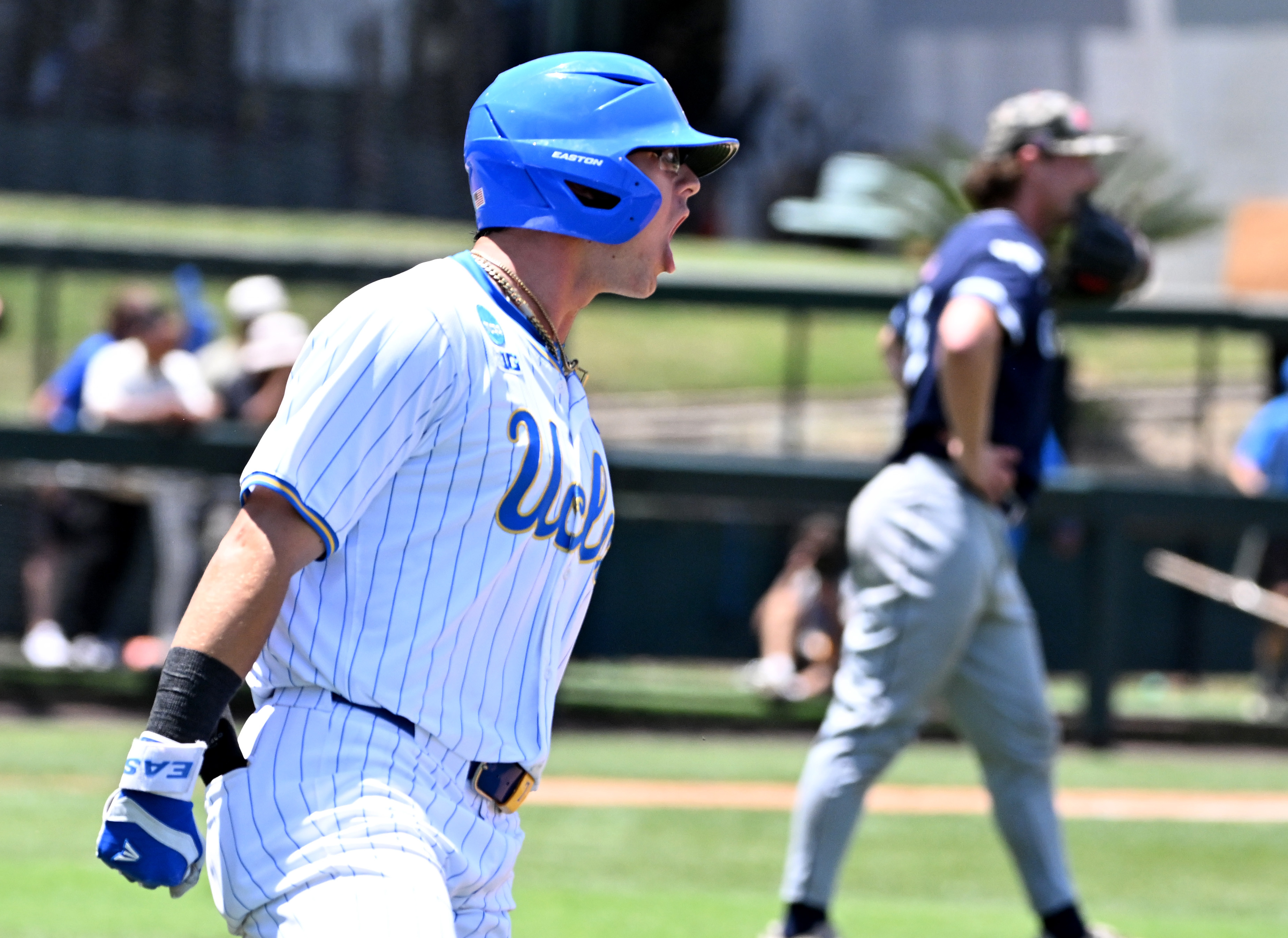 Roman Martin #7 of the UCLA Bruins reacts after hitting...
