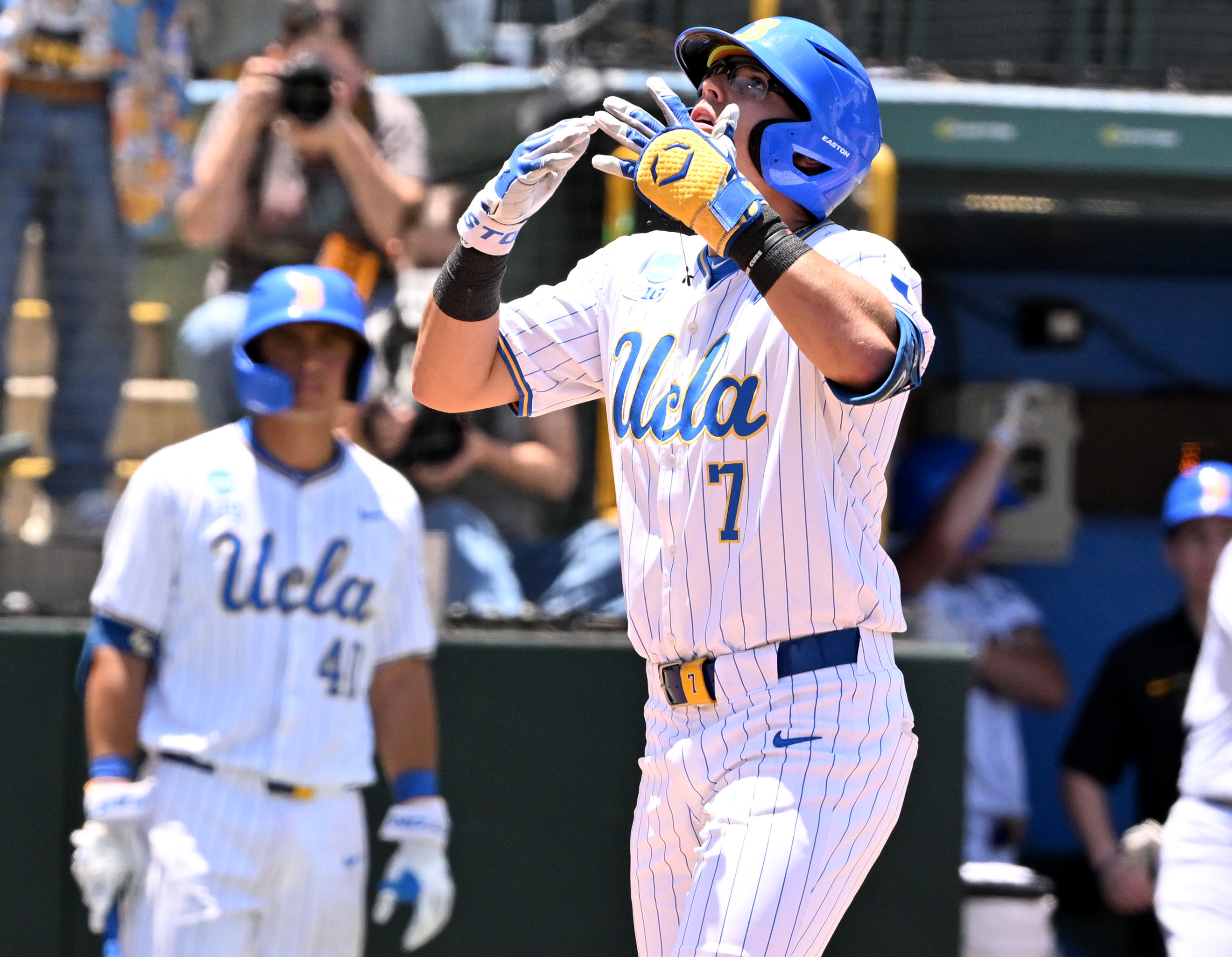 Roman Martin #7 of the UCLA Bruins reacts after hitting...