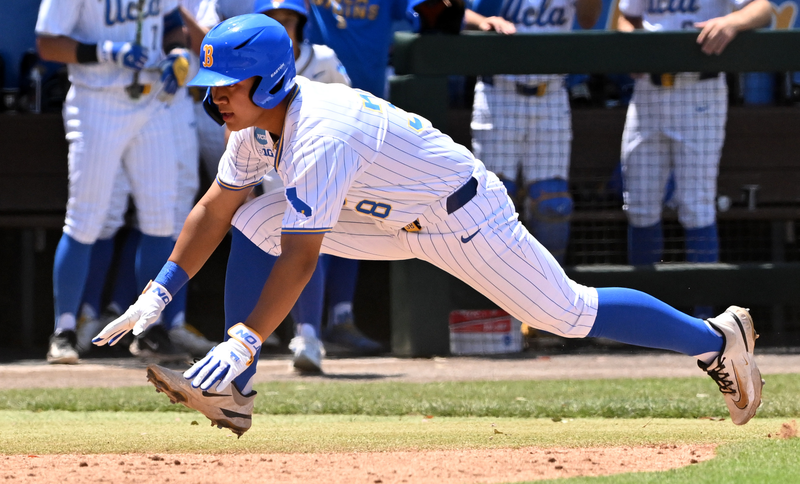 Trey Gudoy #38 of the UCLA Bruins scores on a...