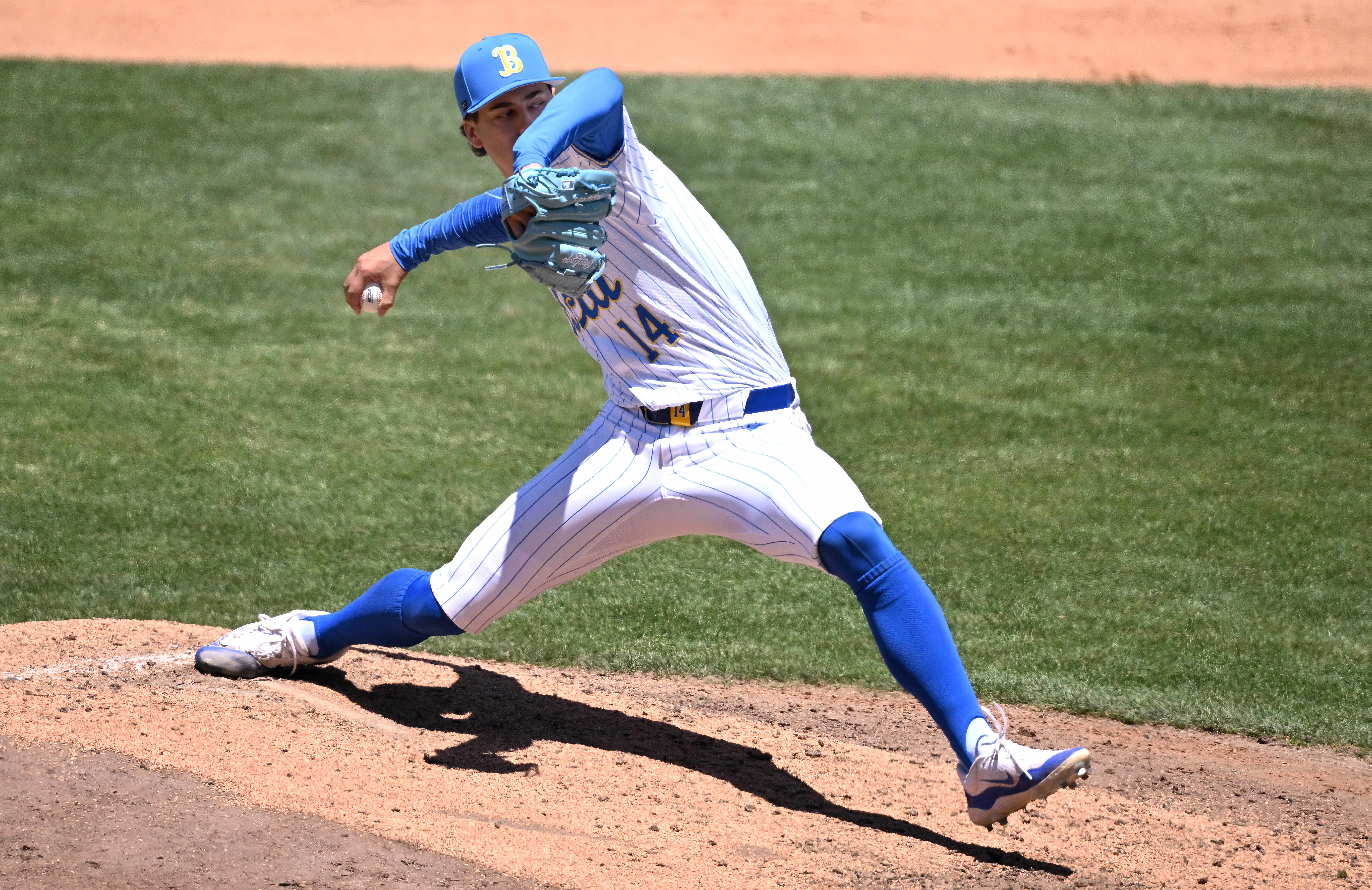 Relief pitcher Landon Stump #14 of the UCLA Bruins throws...