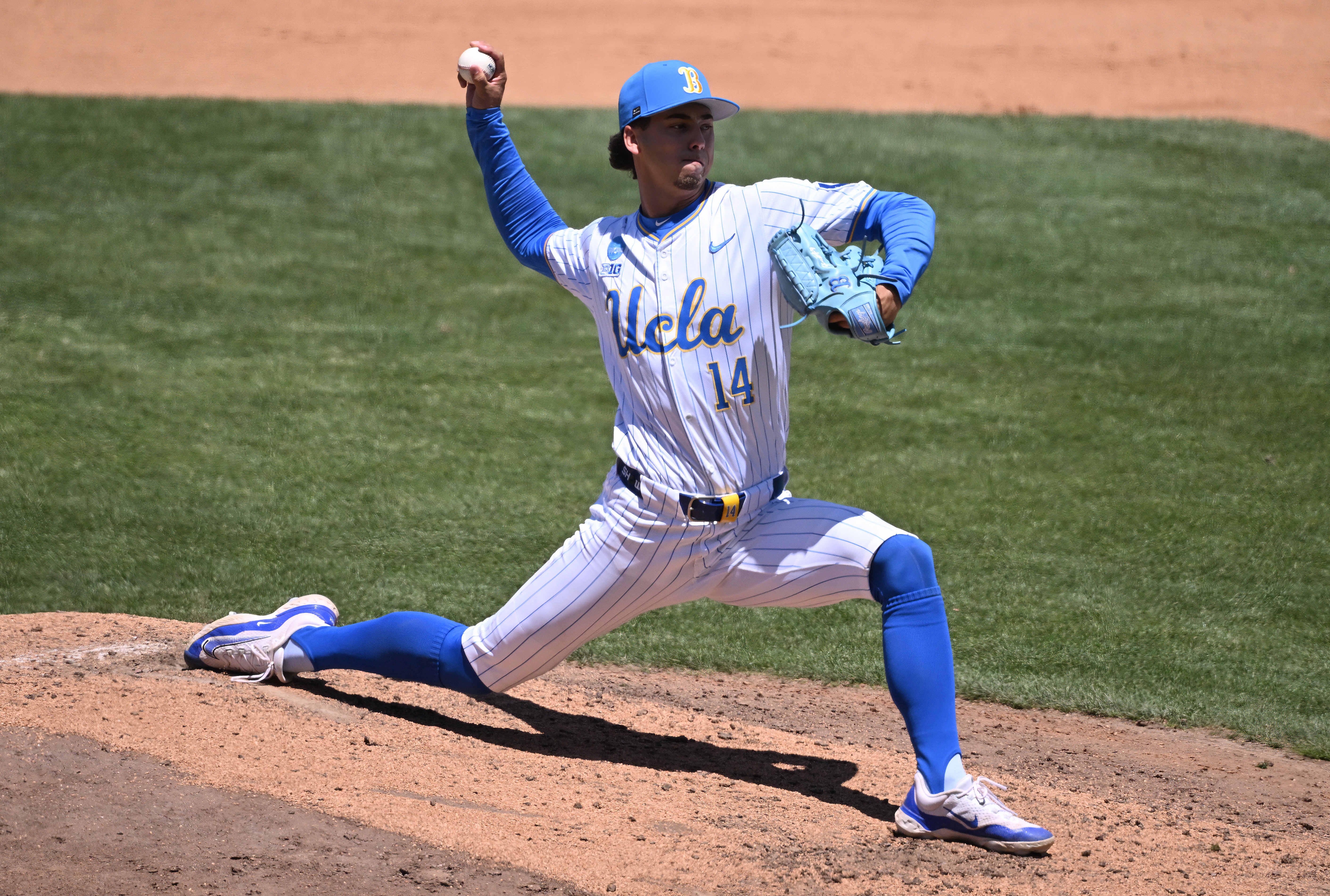 Relief pitcher Landon Stump #14 of the UCLA Bruins throws...