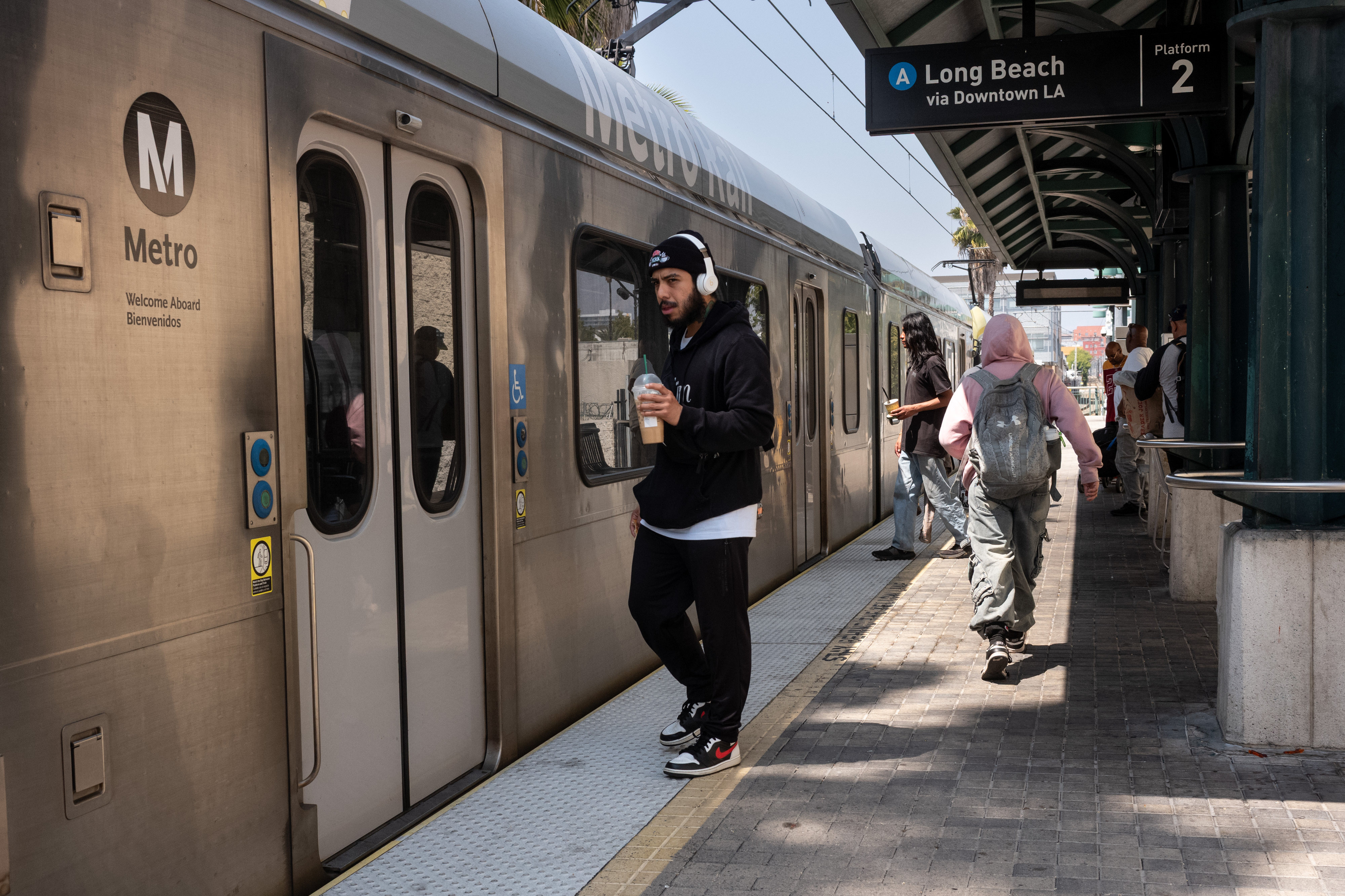 Metro riders board the A line at the Fillmore station...