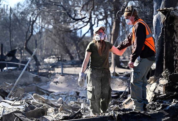A husband and wife comfort each other as they try to pick up the pieces after their home of four years was destroyed along East Harriet St. during the Eaton Fire in Altadena on Saturday, January 11, 2025. (Photo by Keith Birmingham, Pasadena Star-News/SCNG)