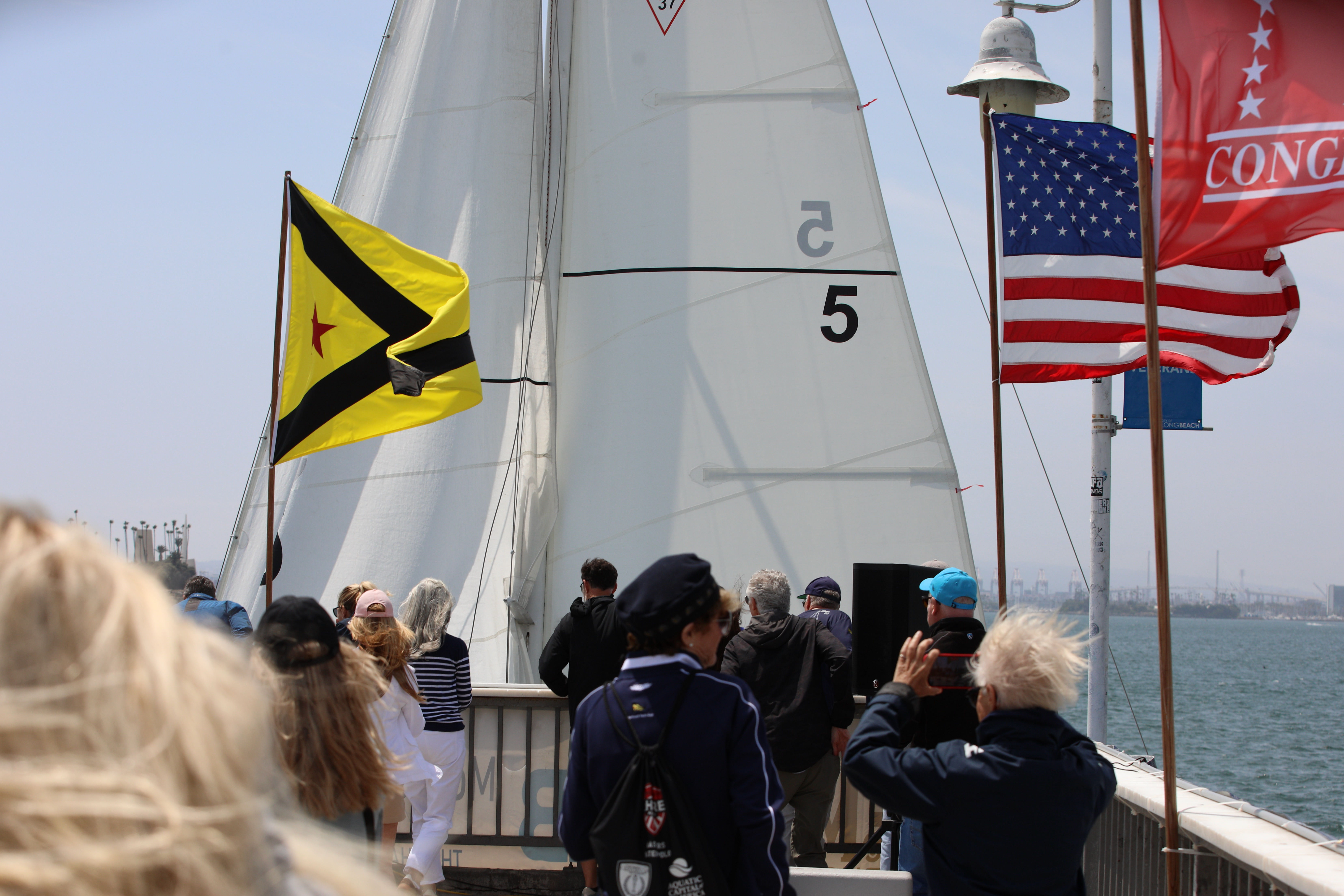 Spectators watch as the action brushes up against the Belmont...