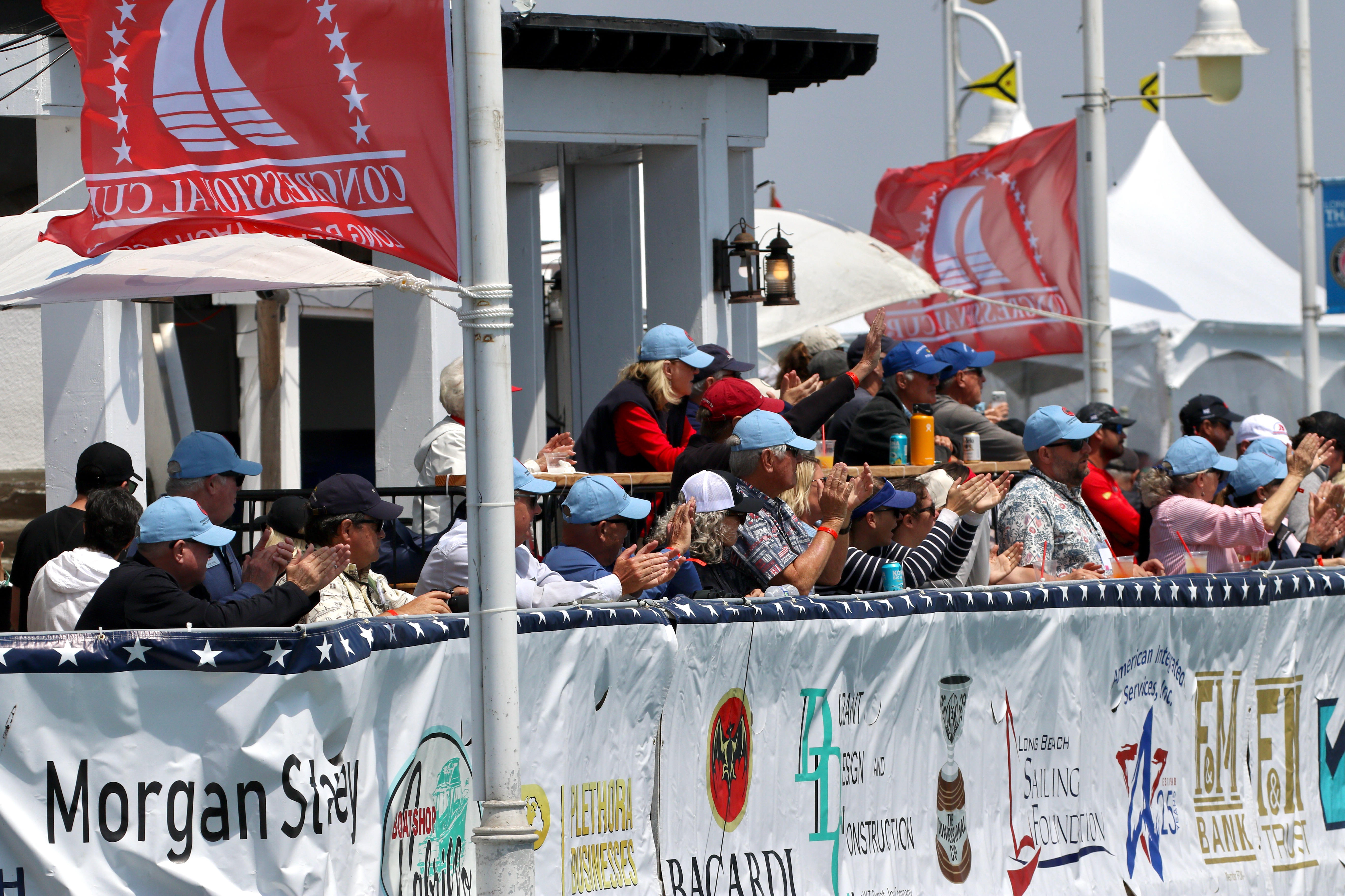 Spectators watch the Congressional Cup from the Belmont Pier on...