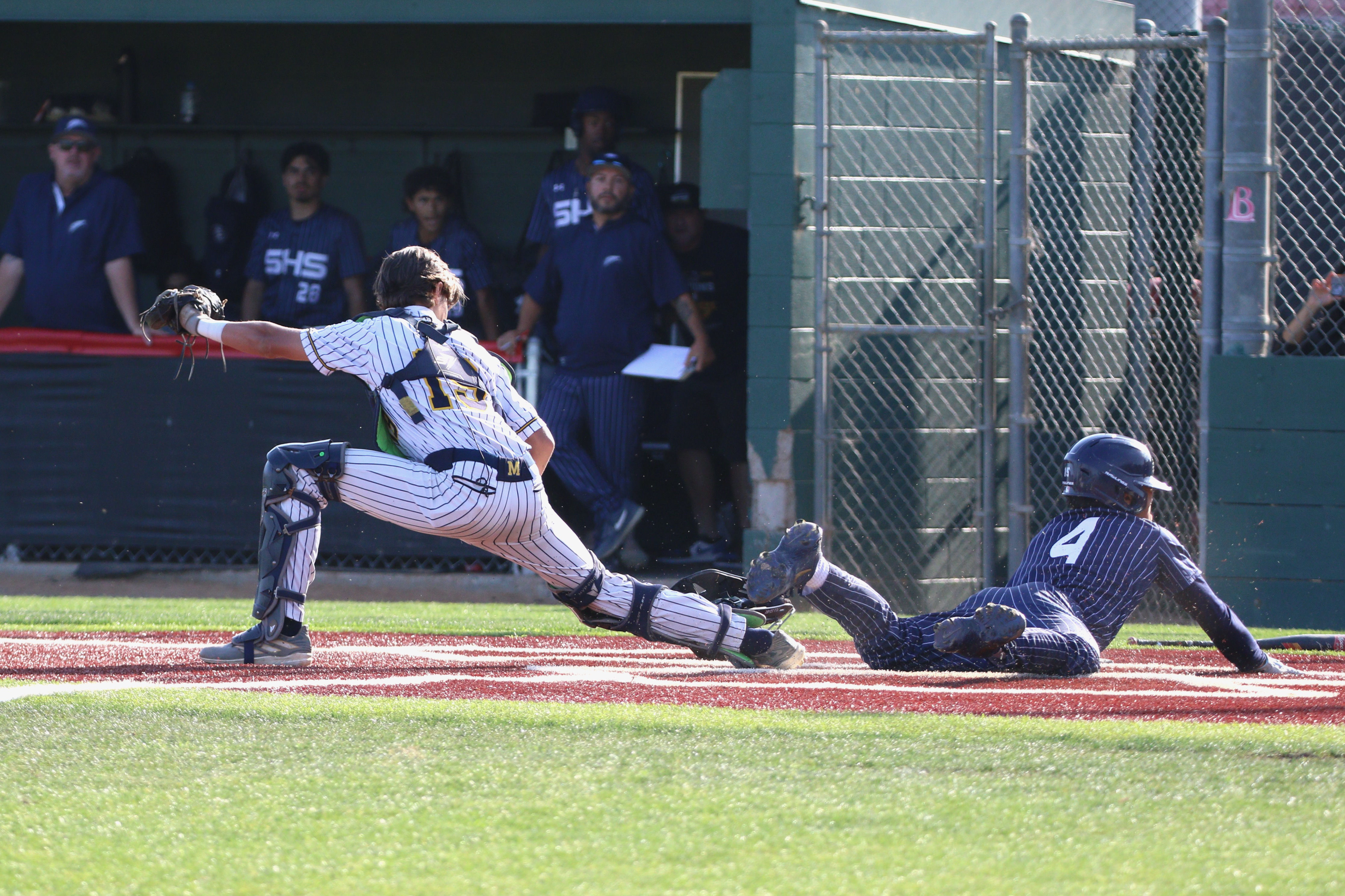 Summitâs Aiden Garcia is out at home sliding head first...