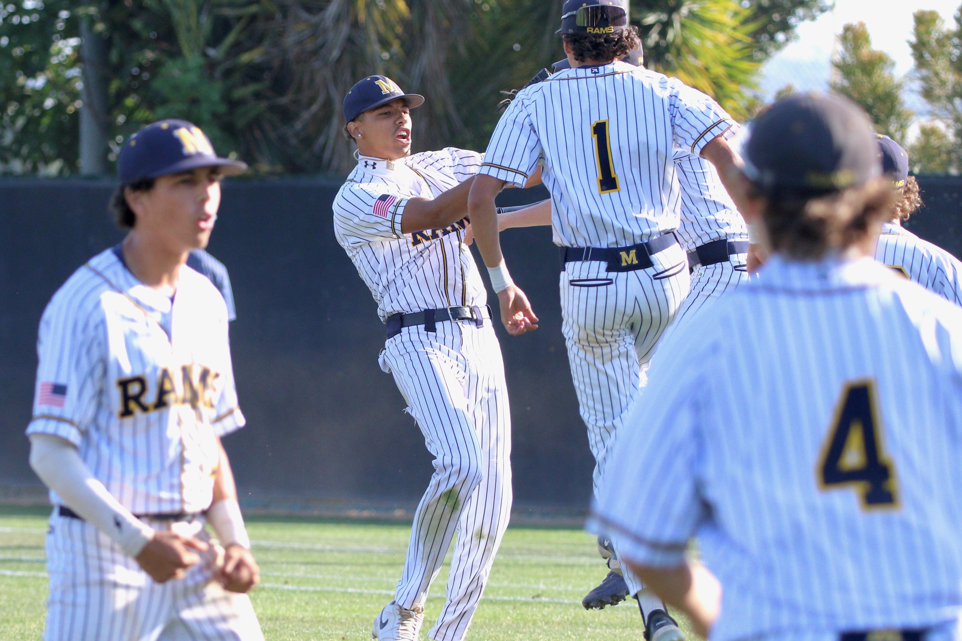 Millikan pitcher Daunte Bell, second from left, and his teammates...