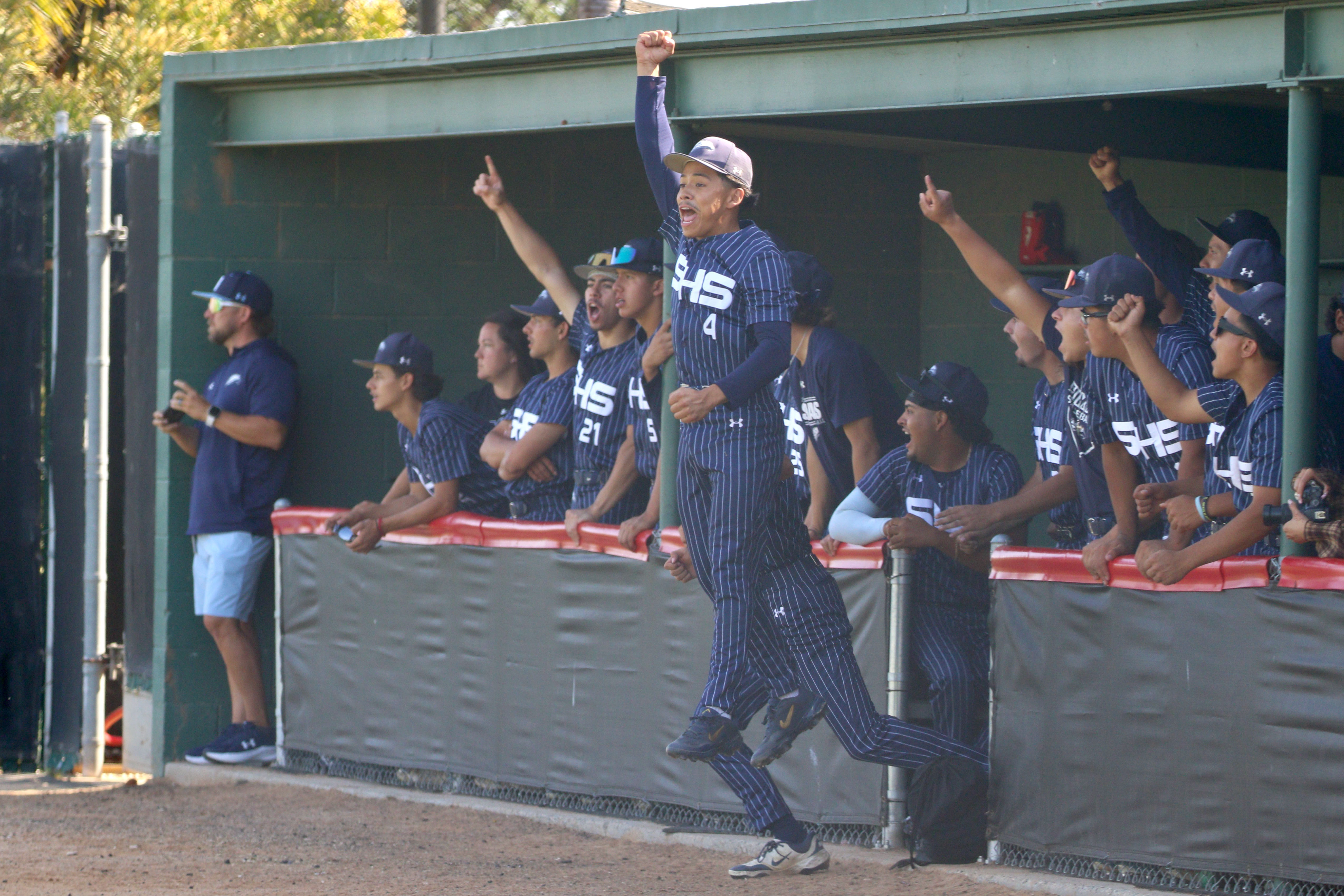 Summit players cheer from the dugout during Division 3 quarterfinal...