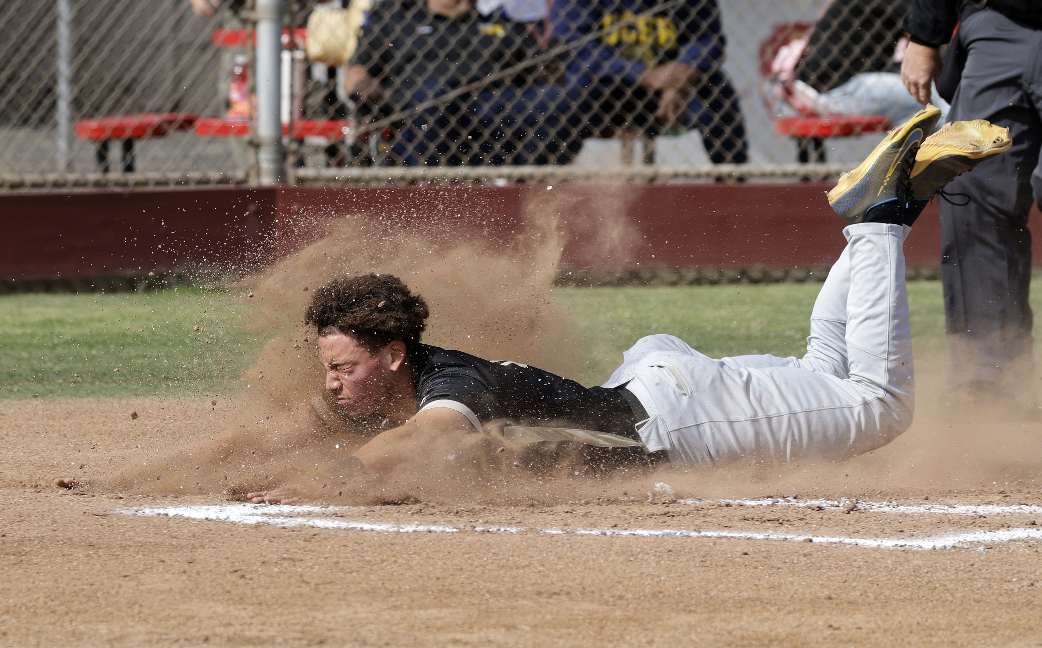 Long Beach Poly’s Tate Hammond (3) slides into home plate...