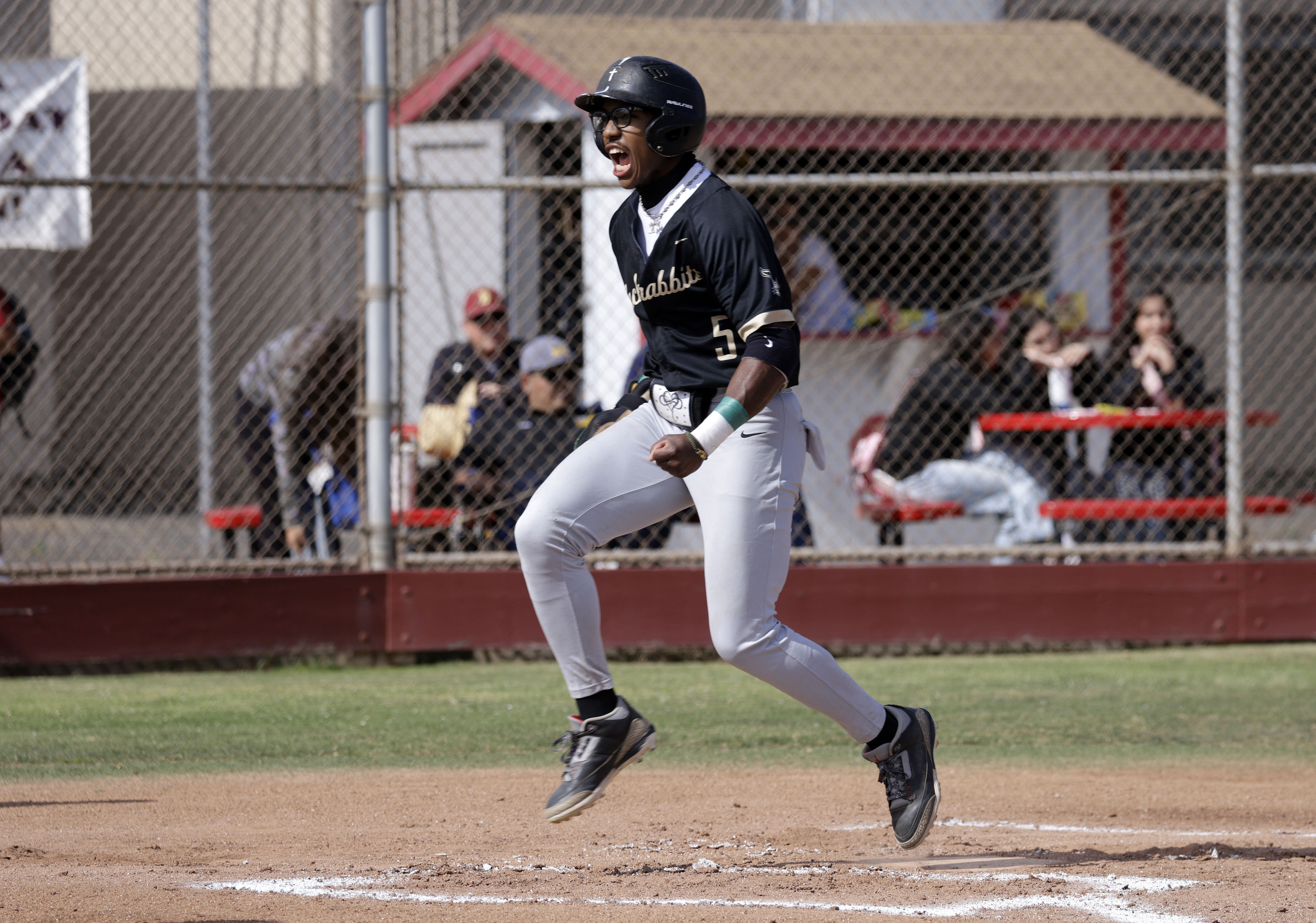 Long Beach Poly’s Freddie Parish IV (5) scores for the...