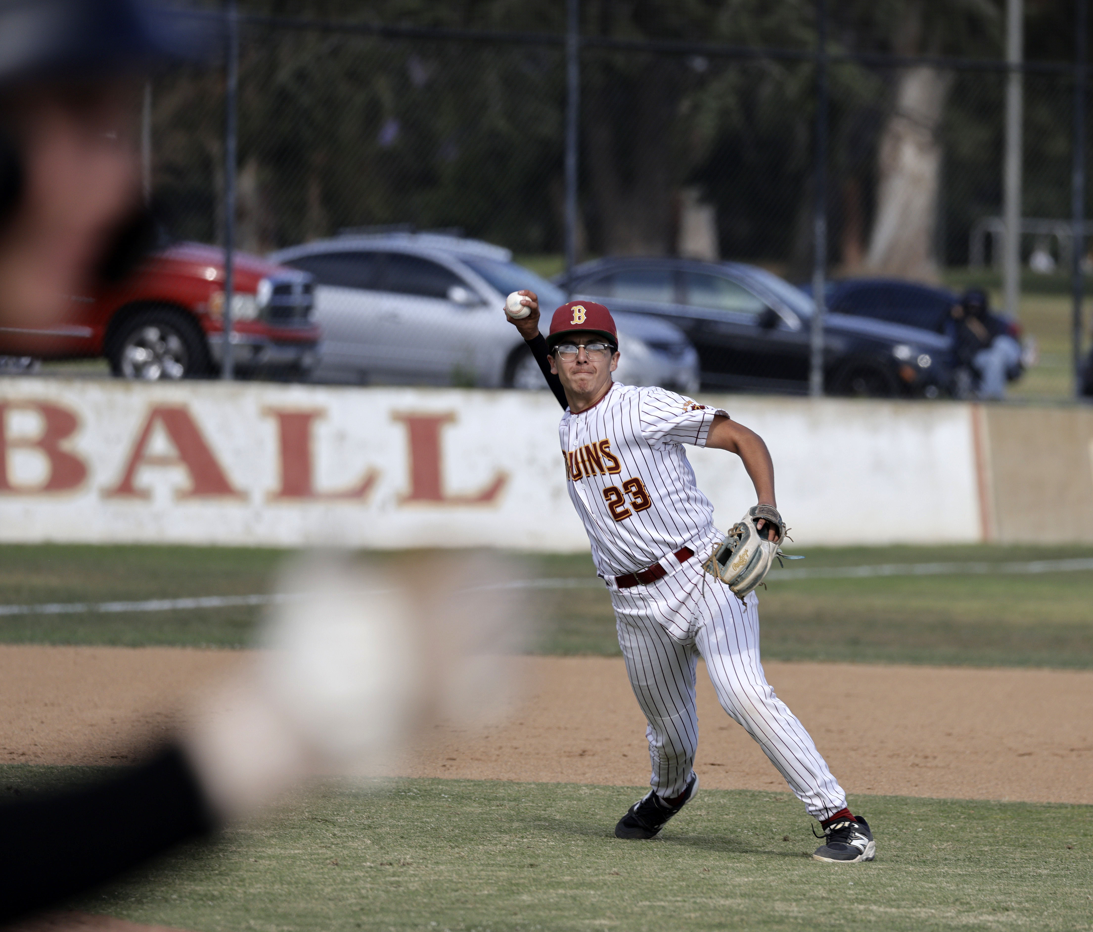 Wilson’s Cesar Castro (23) looks to throw the out at...