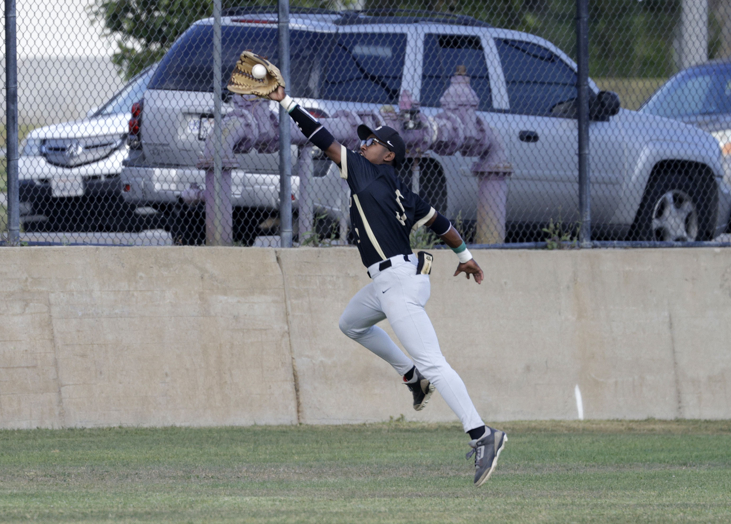 Long Beach Poly’s Freddie Parish IV (5) reaches for the...