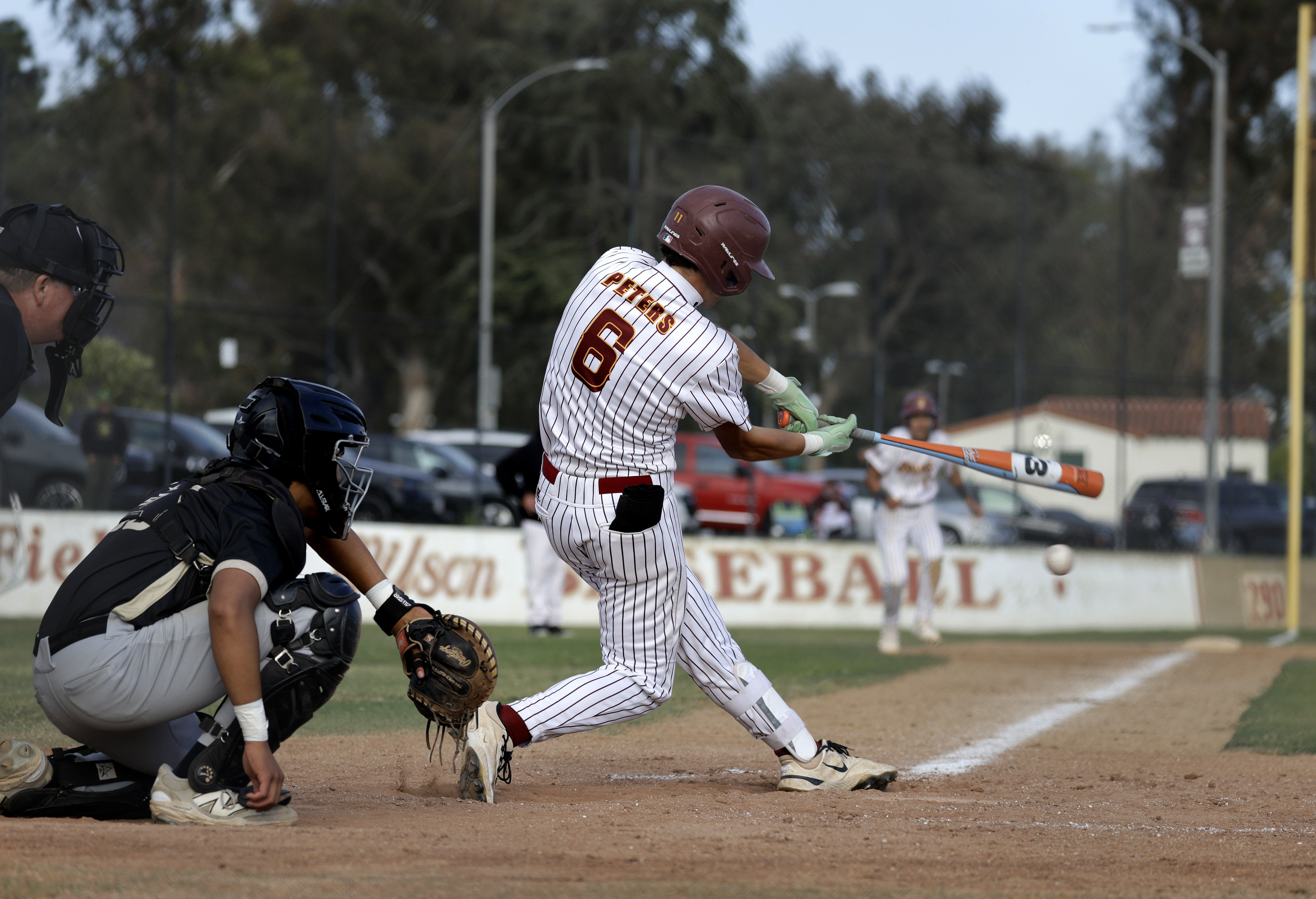 Wilson’s Penn Peters (6) looks to bat in a runner...