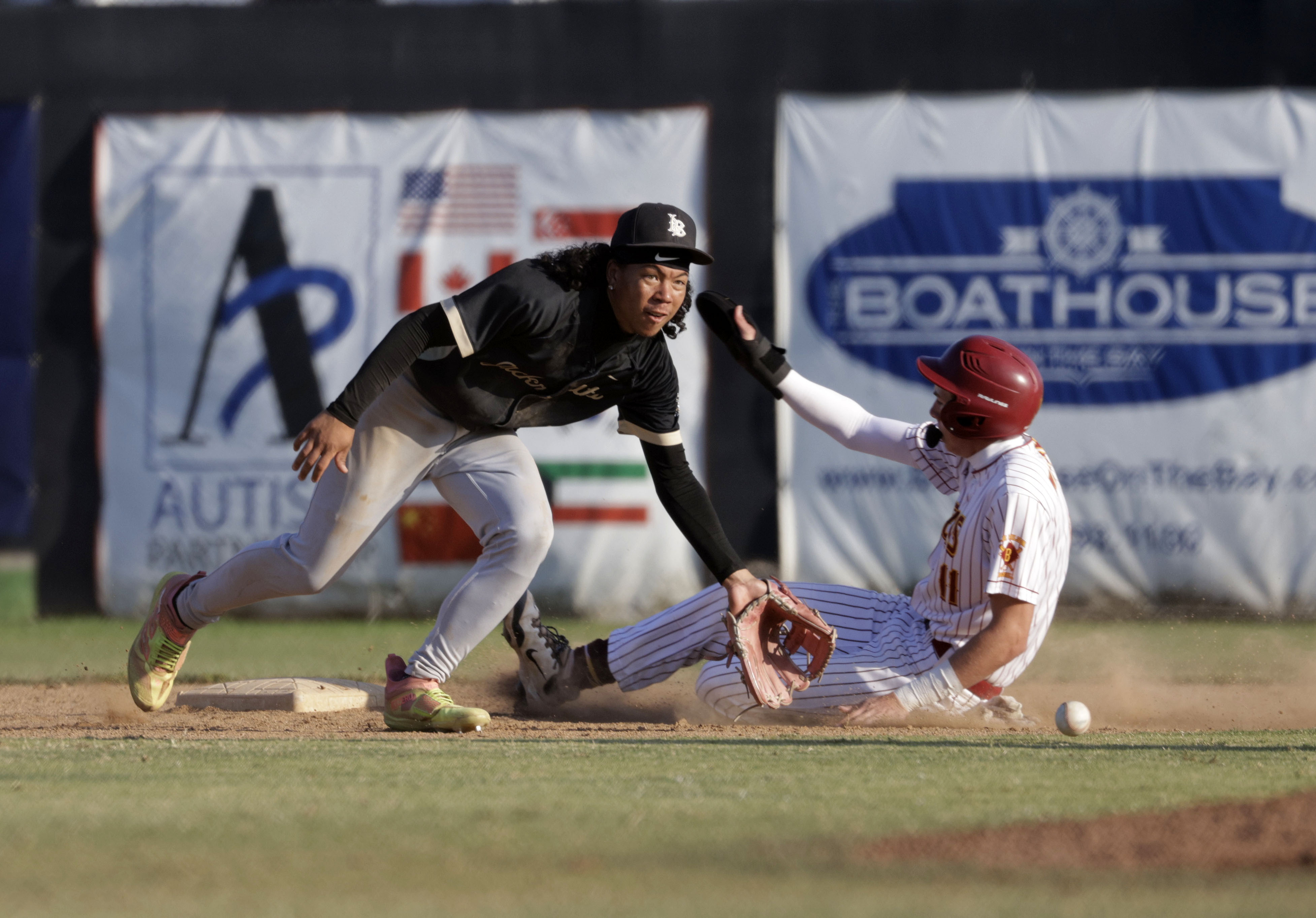 Long Beach Poly’s Malakai Pruitt (2) tries to get Wilsons...