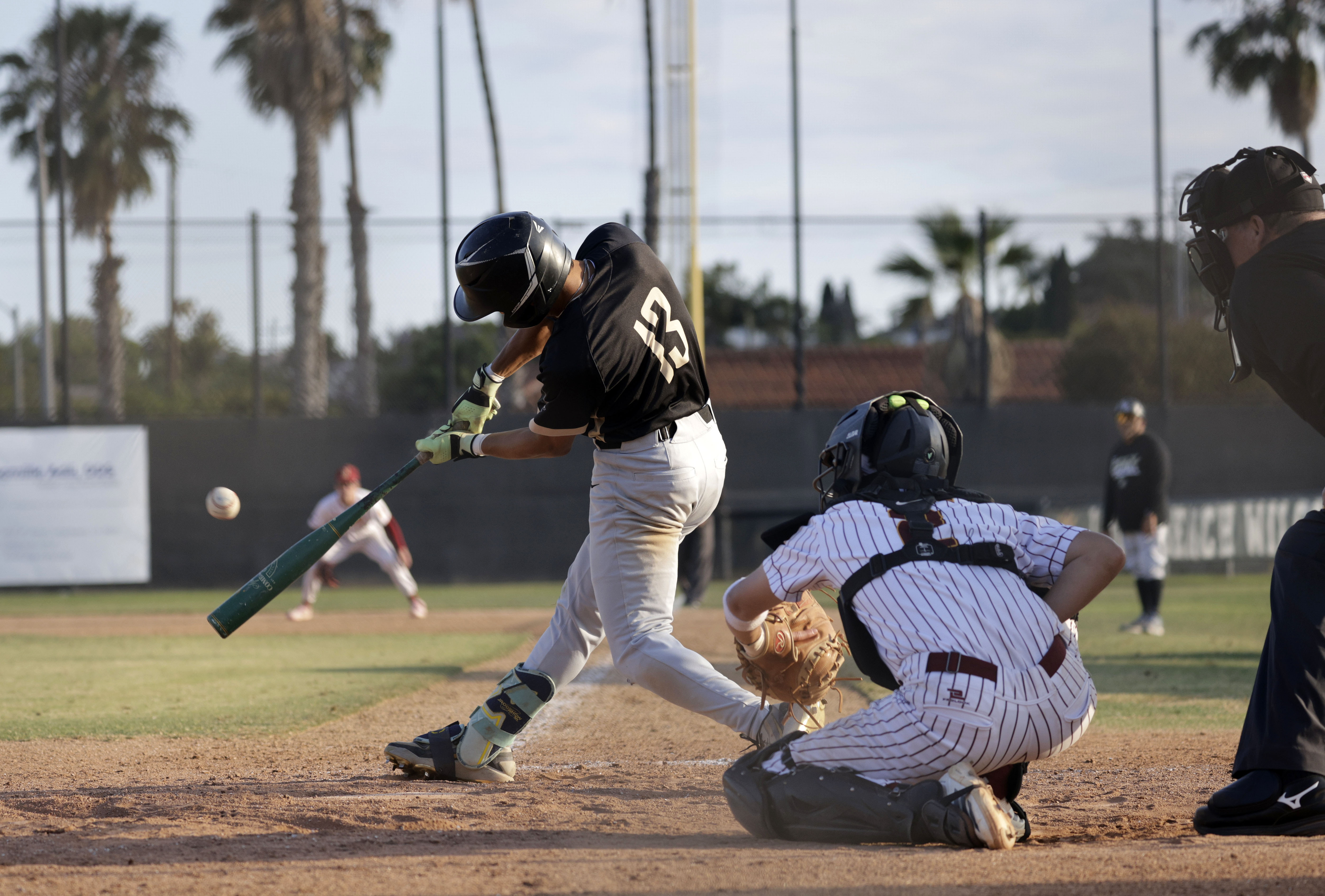 Long Beach Poly’s Fausto Gaxiola III (13) slams the ball...