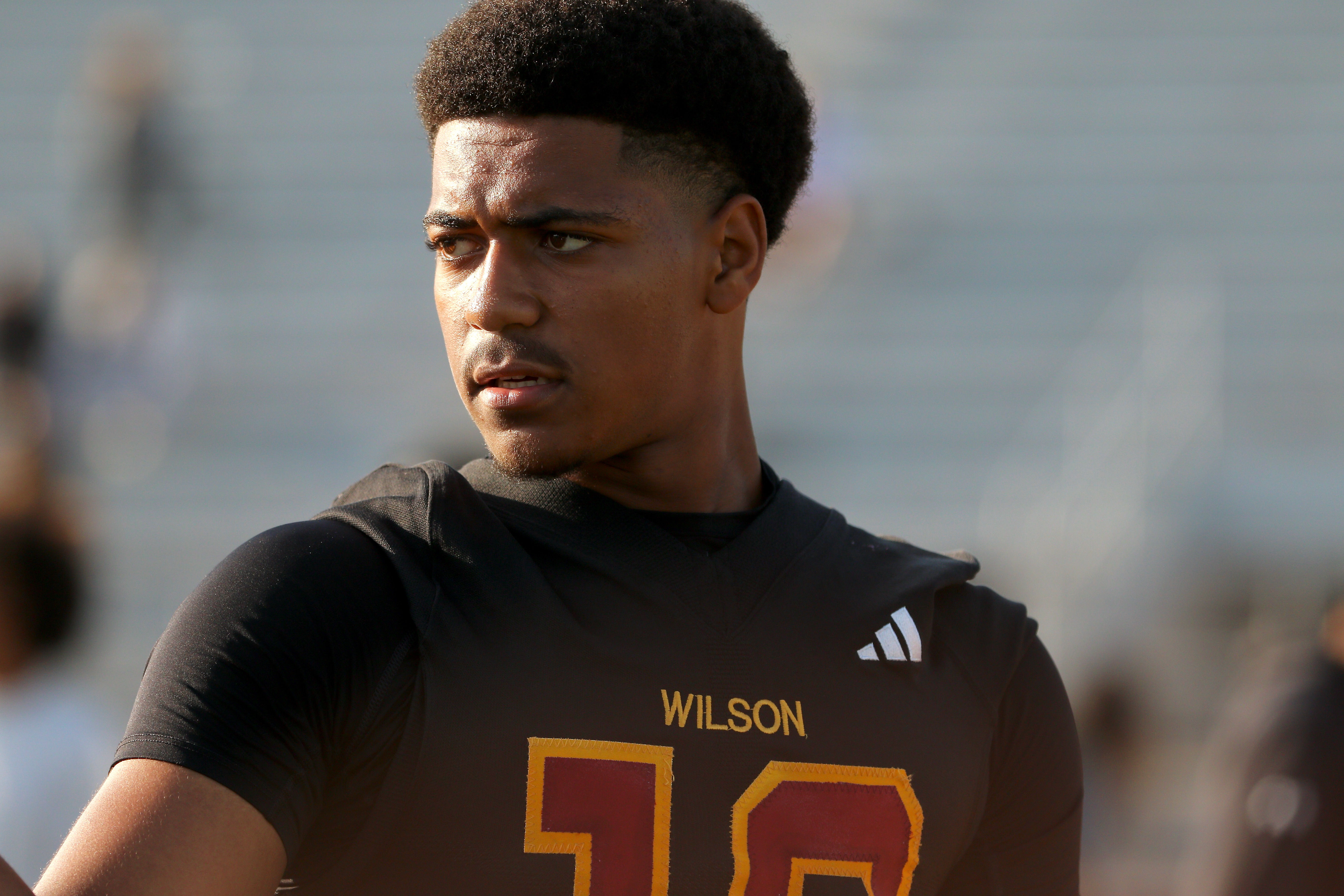 Wilson quarterback Jacob Powell takes part in a spring football...