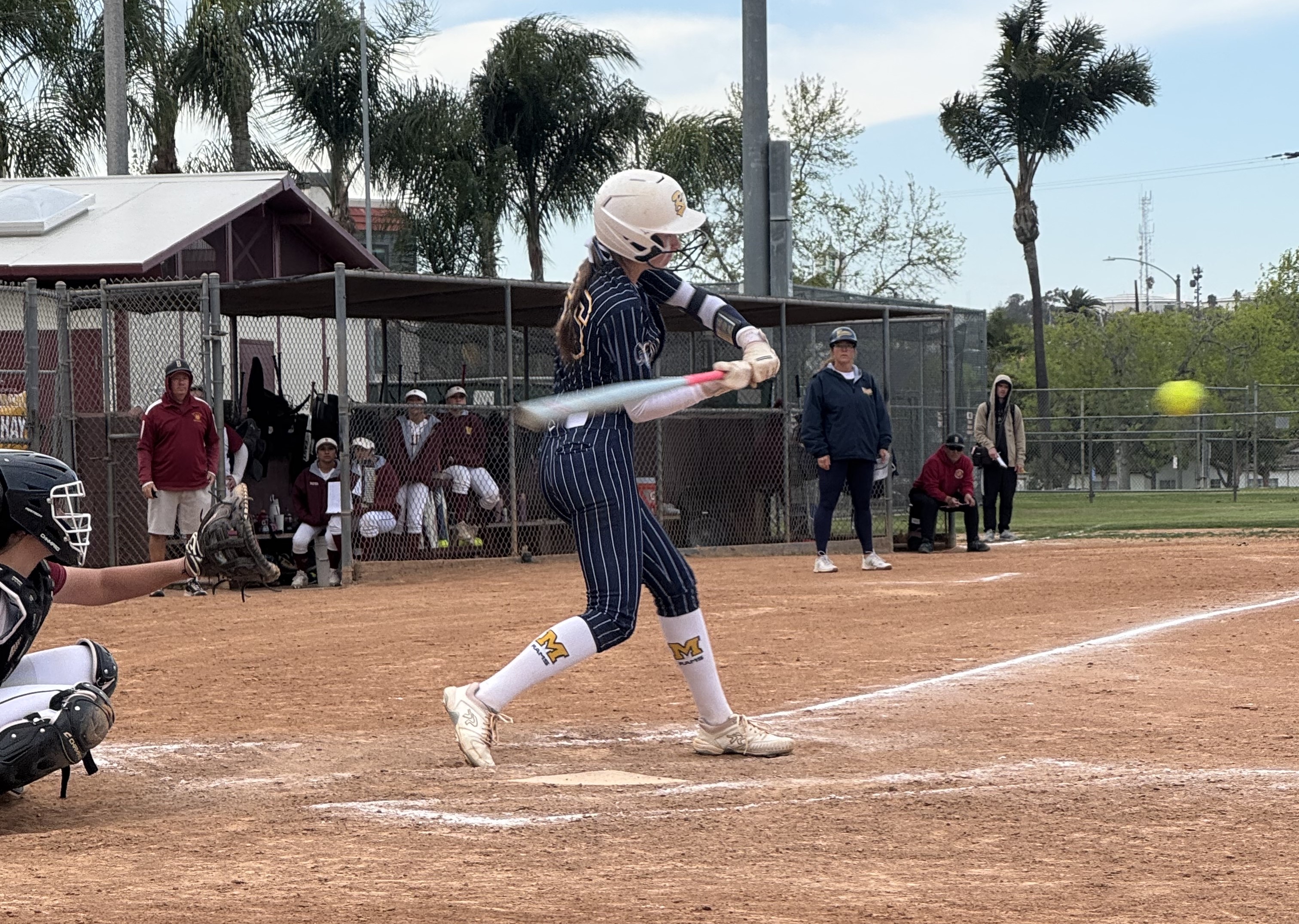 Millikan’s Riley McAndrew swings at a pitch during a Moore...