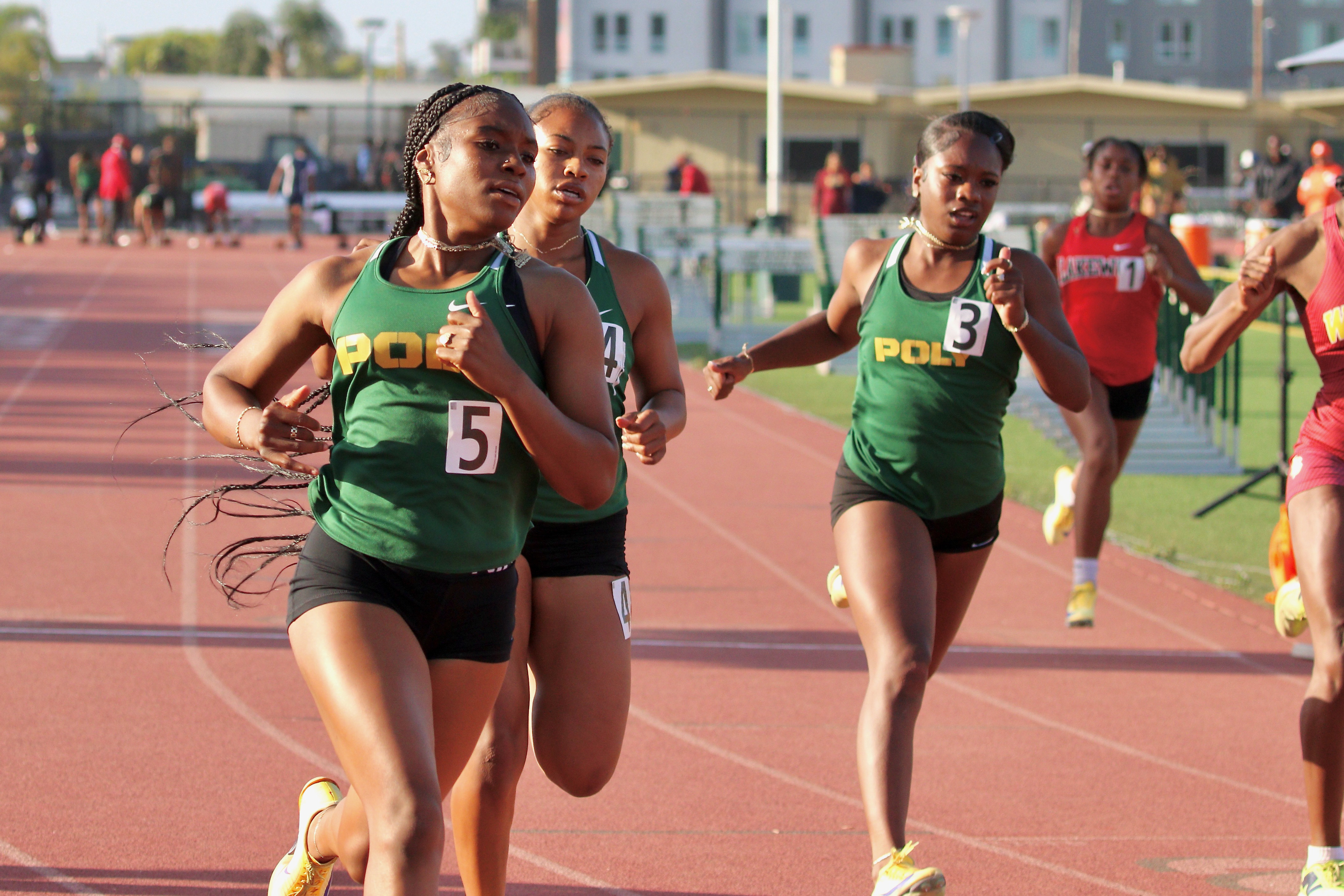 Polyâs Aniyah Brooks, left, finishes in first place in the...