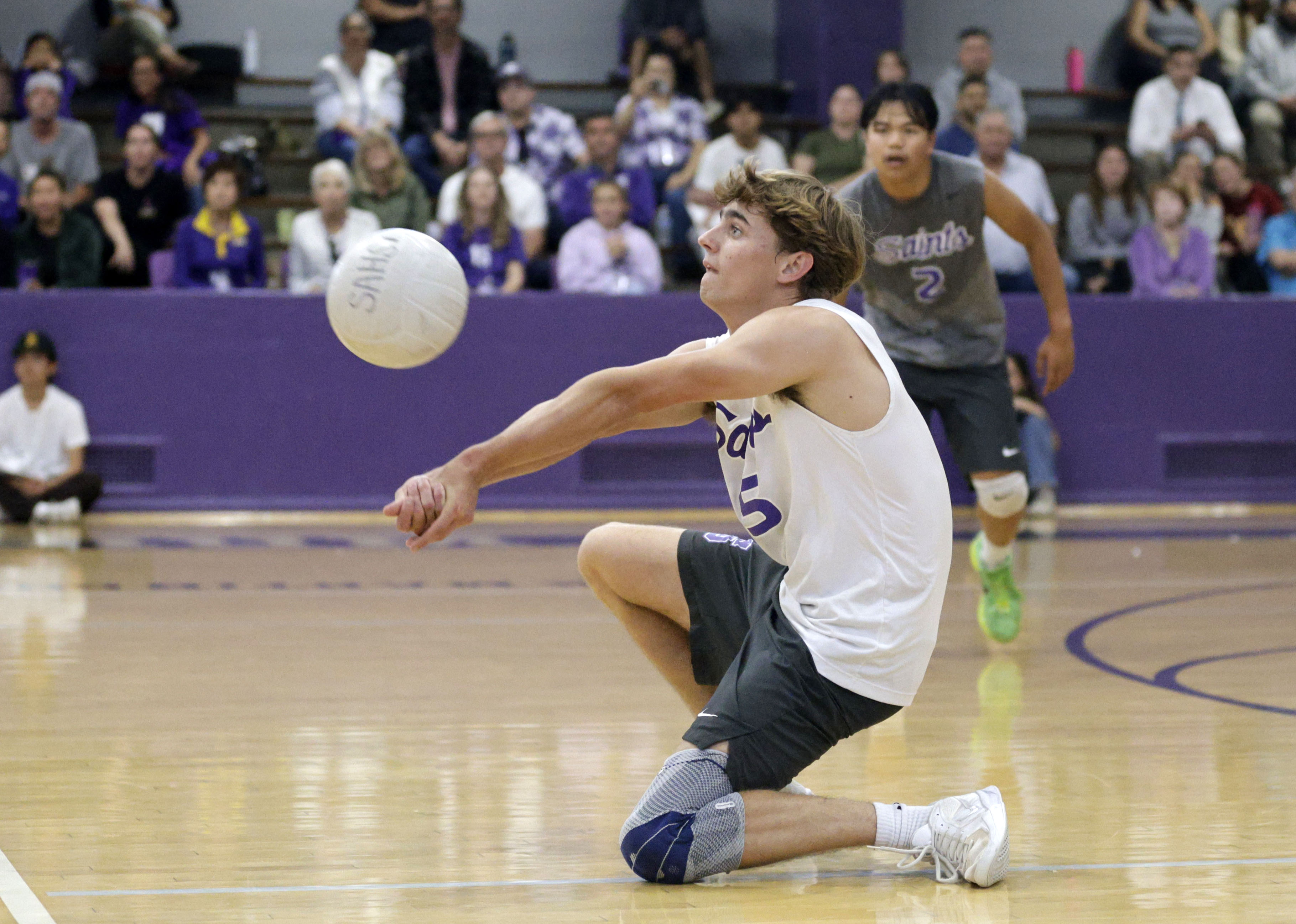St. Anthony’s Jack Furlow returns the serve as the Saints...
