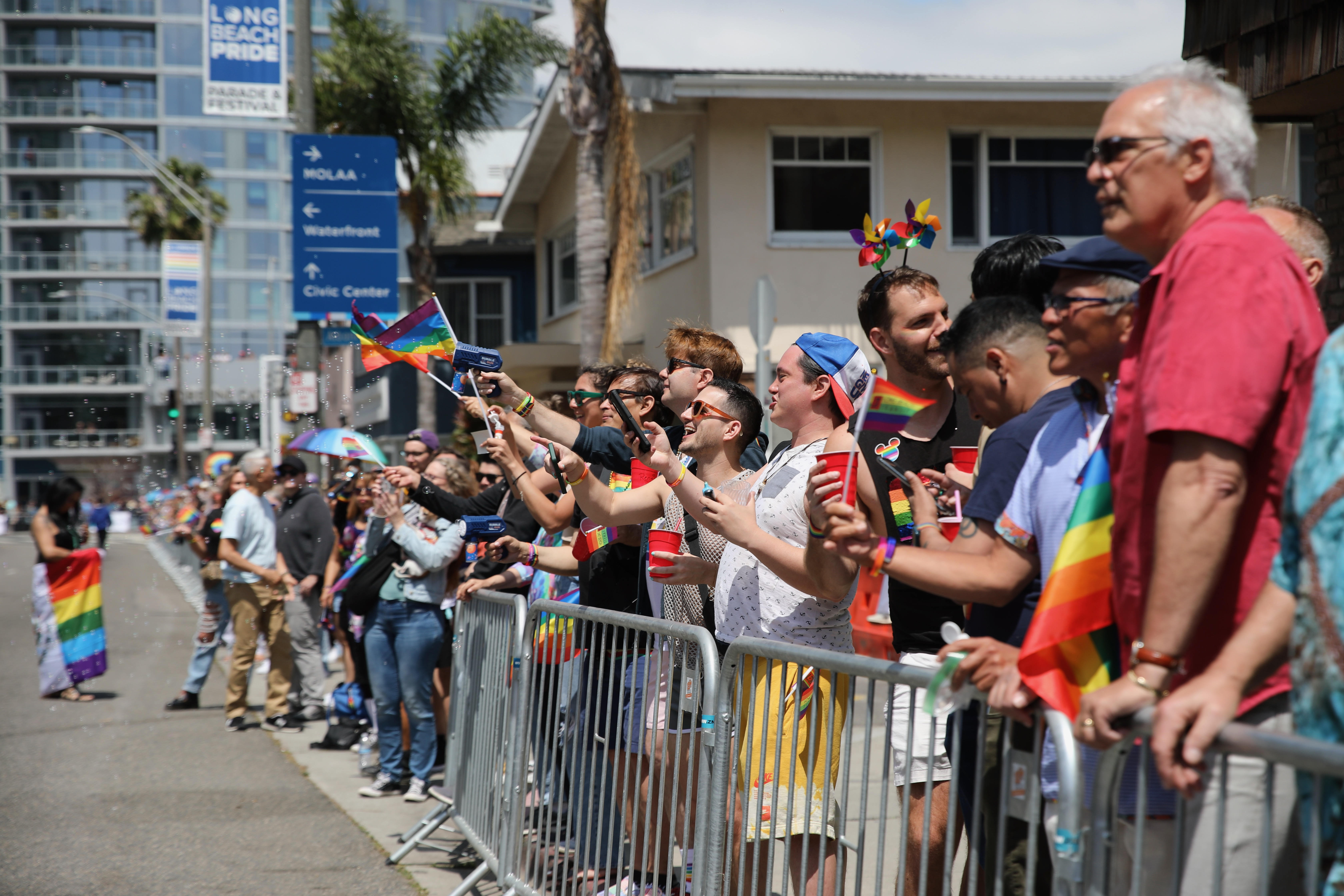Spectators line the parade route along Ocean Boulevard for the...