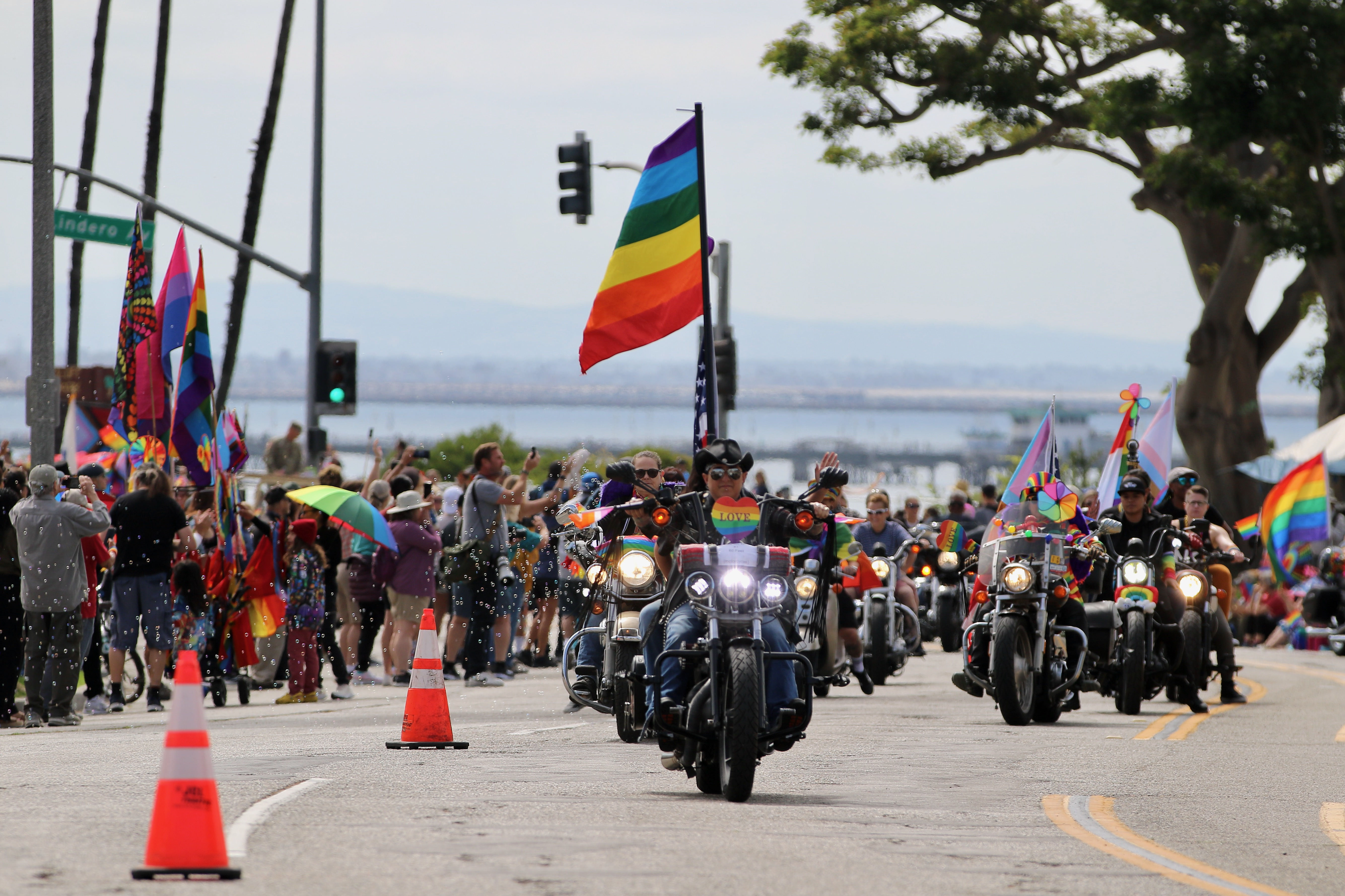 Participants on motorcycles ride west along Ocean Boulevard at the...