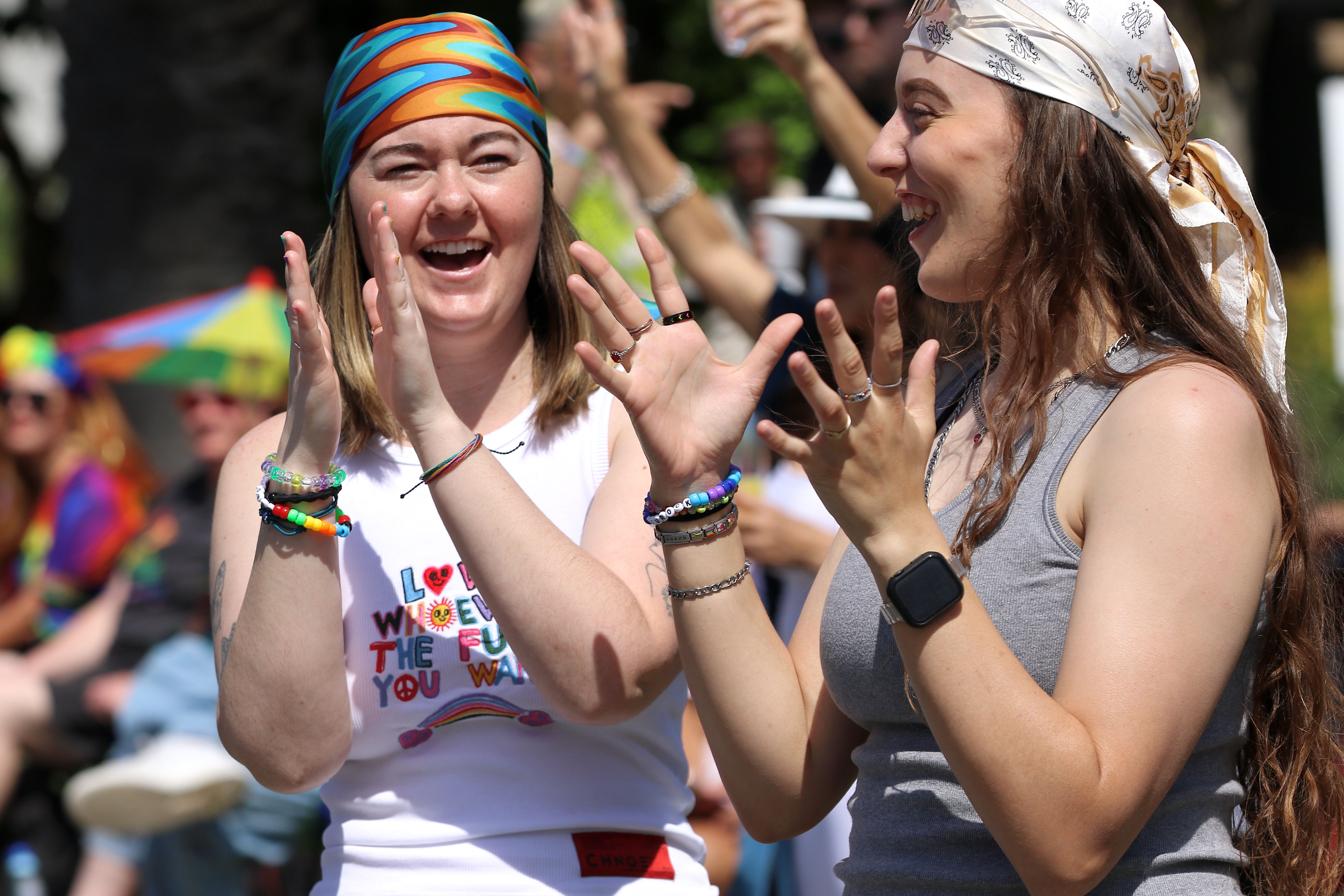 Spectators line the parade route along Ocean Boulevard for the...