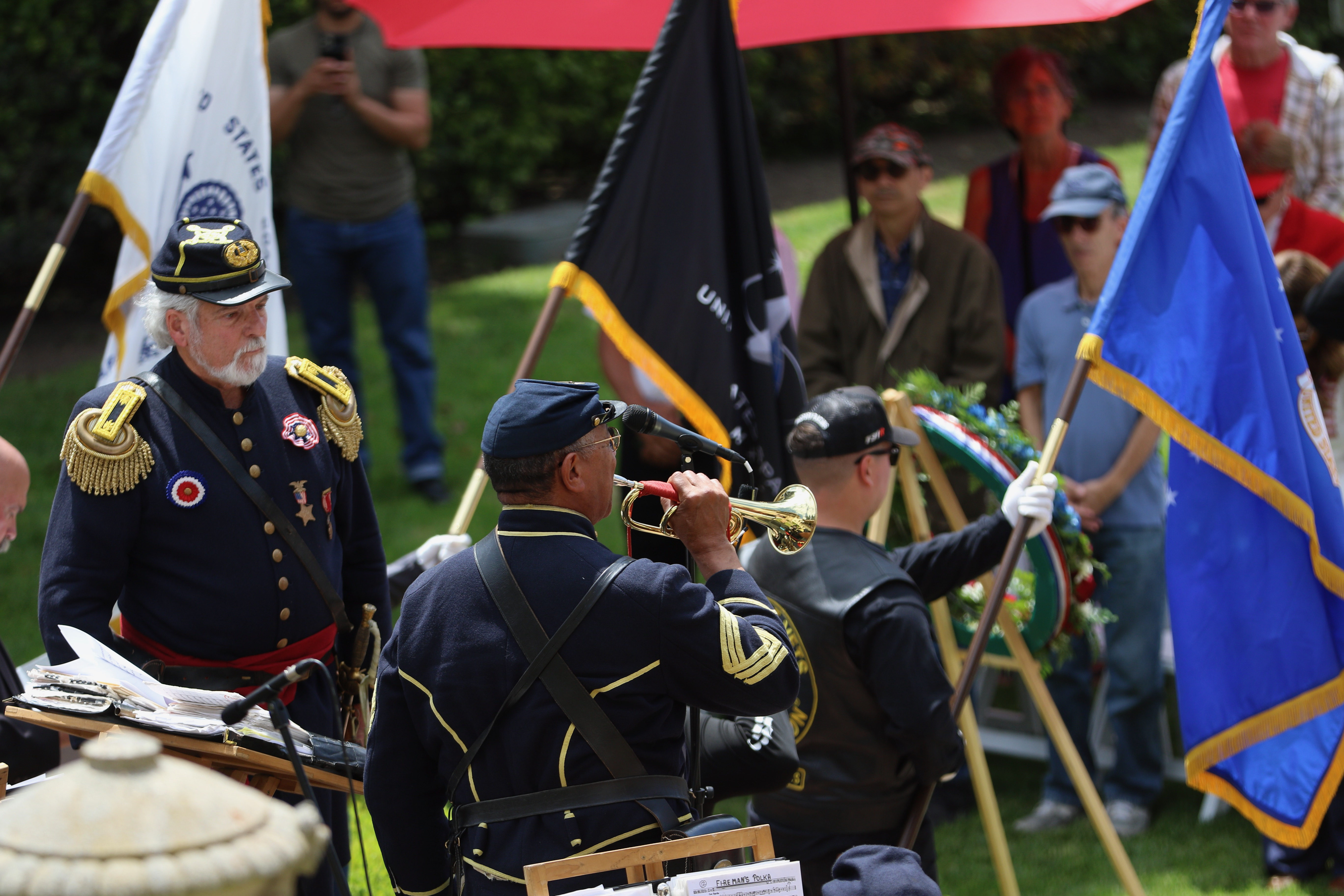 A bugler performs Taps in honor of members of the...